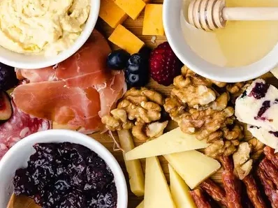 Artisanal charcuterie board with assorted cheeses and fruits