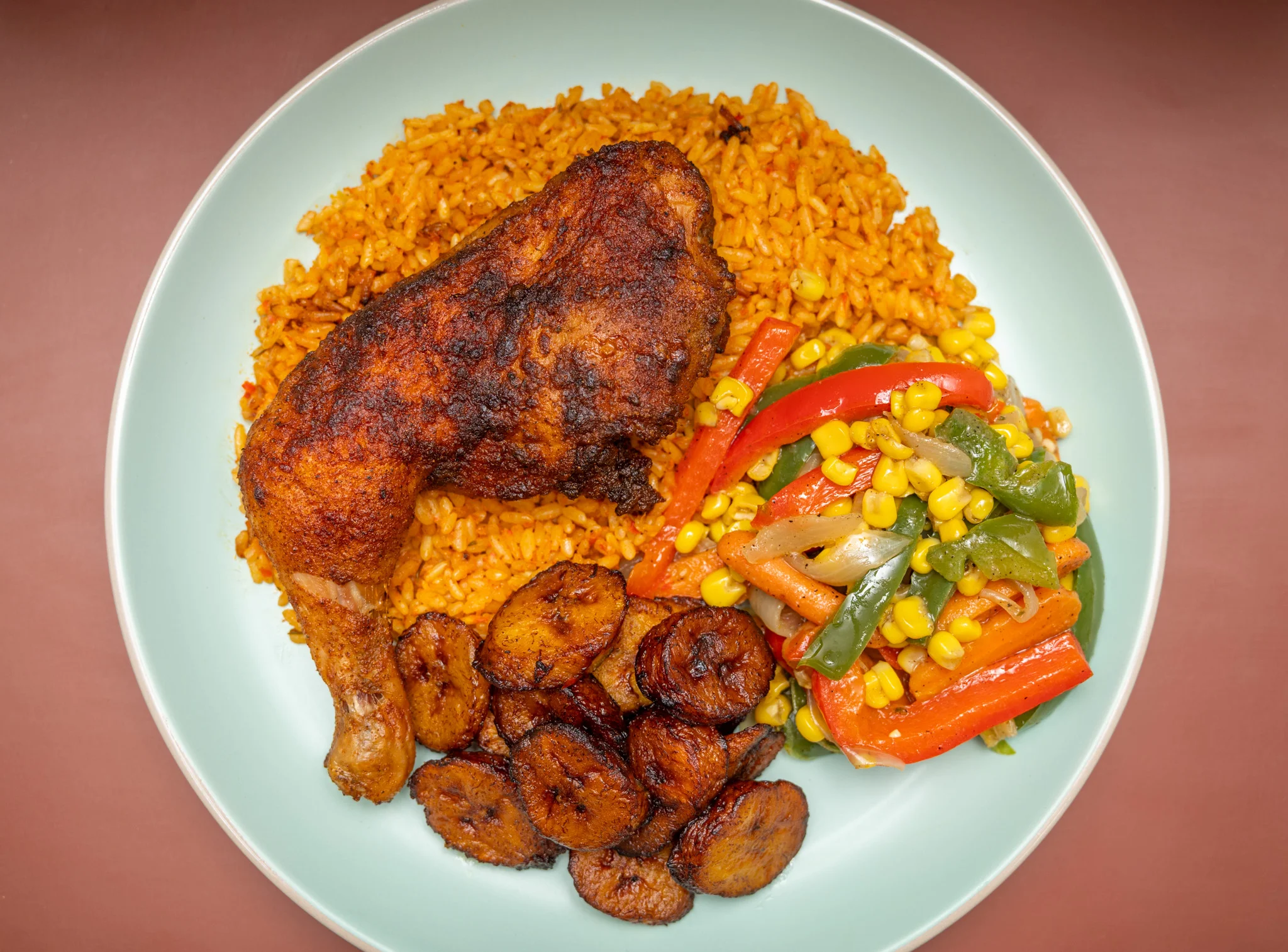 Delicious Suya skewers served on a plate with fresh vegetables.