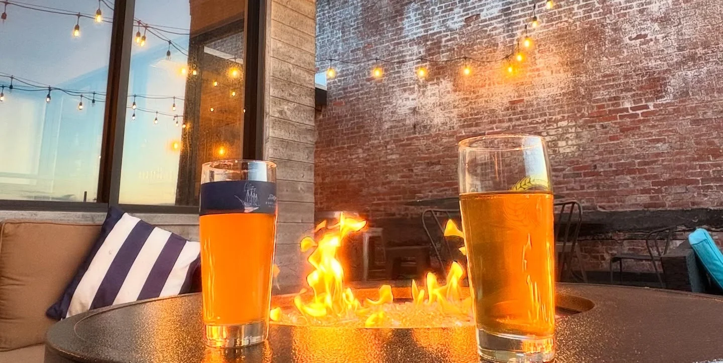 Outdoor bar setting with drinks and fire pit