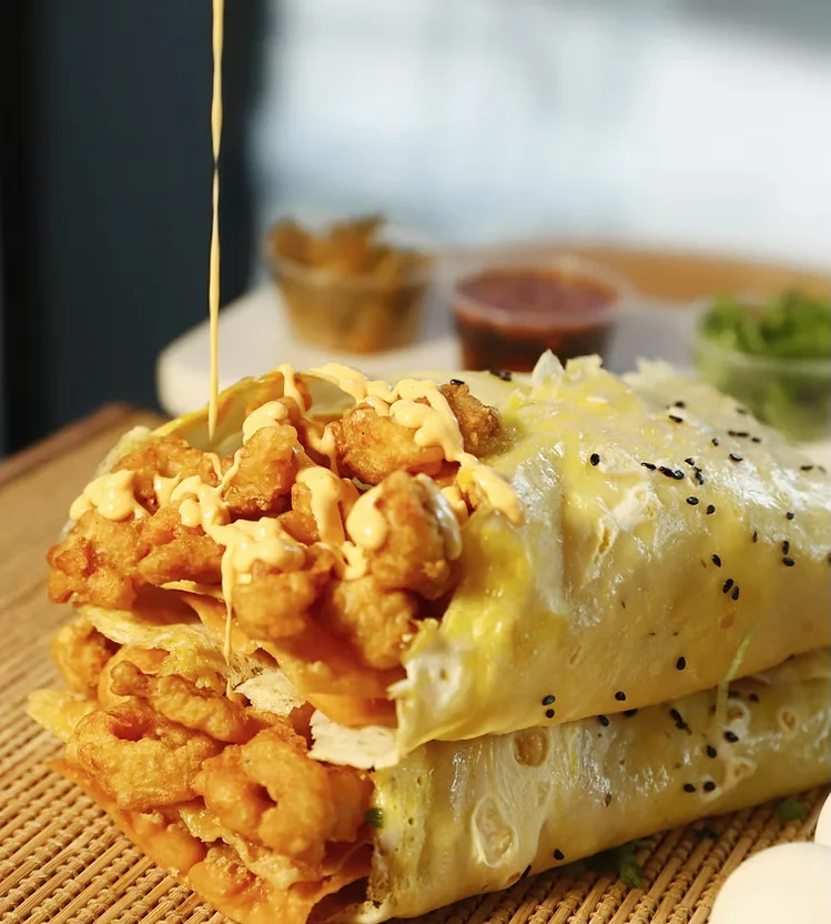 Crispy Indian kathi roll with fried chicken and sauces