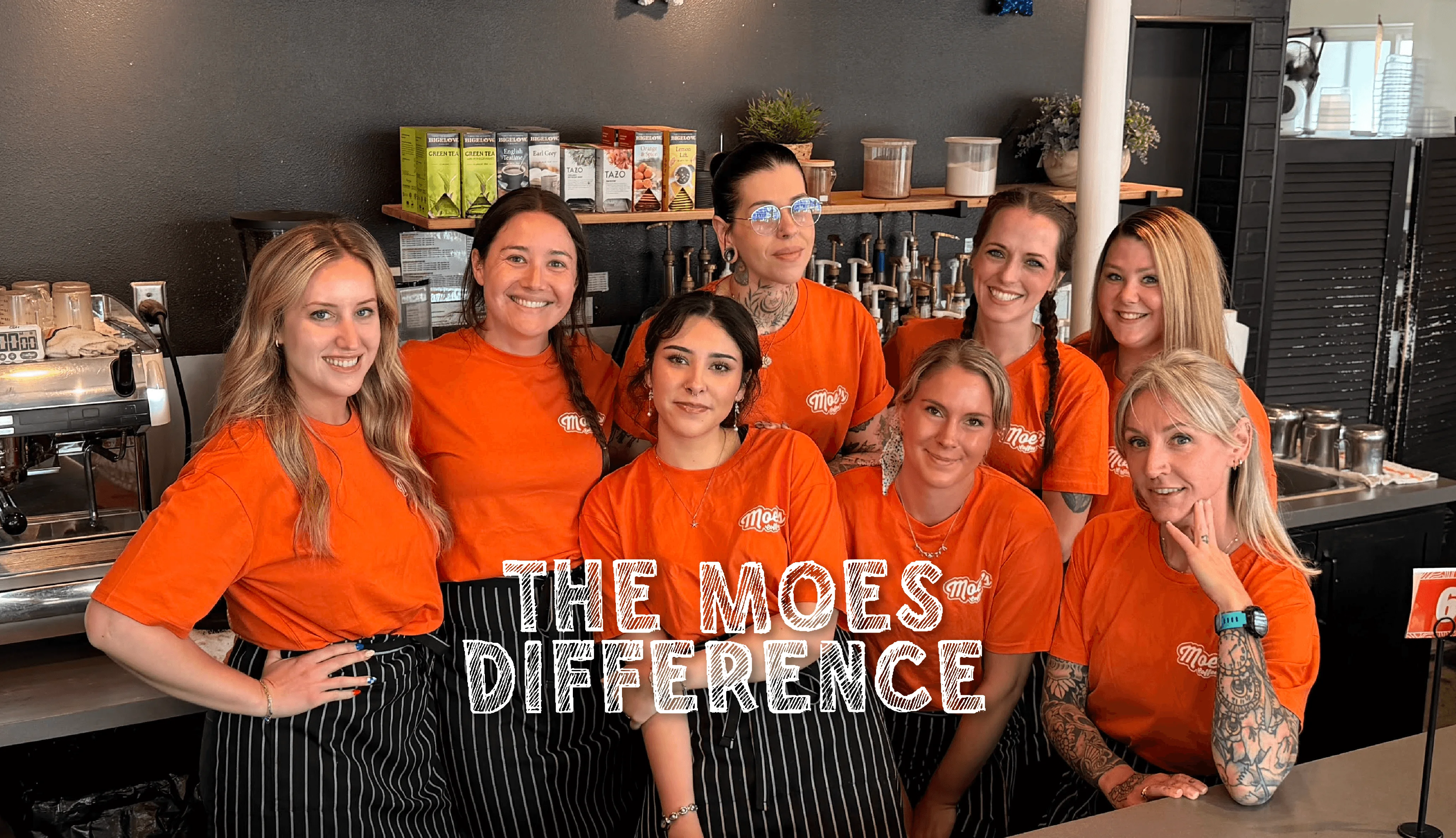 Team of baristas in orange shirts at a coffee shop