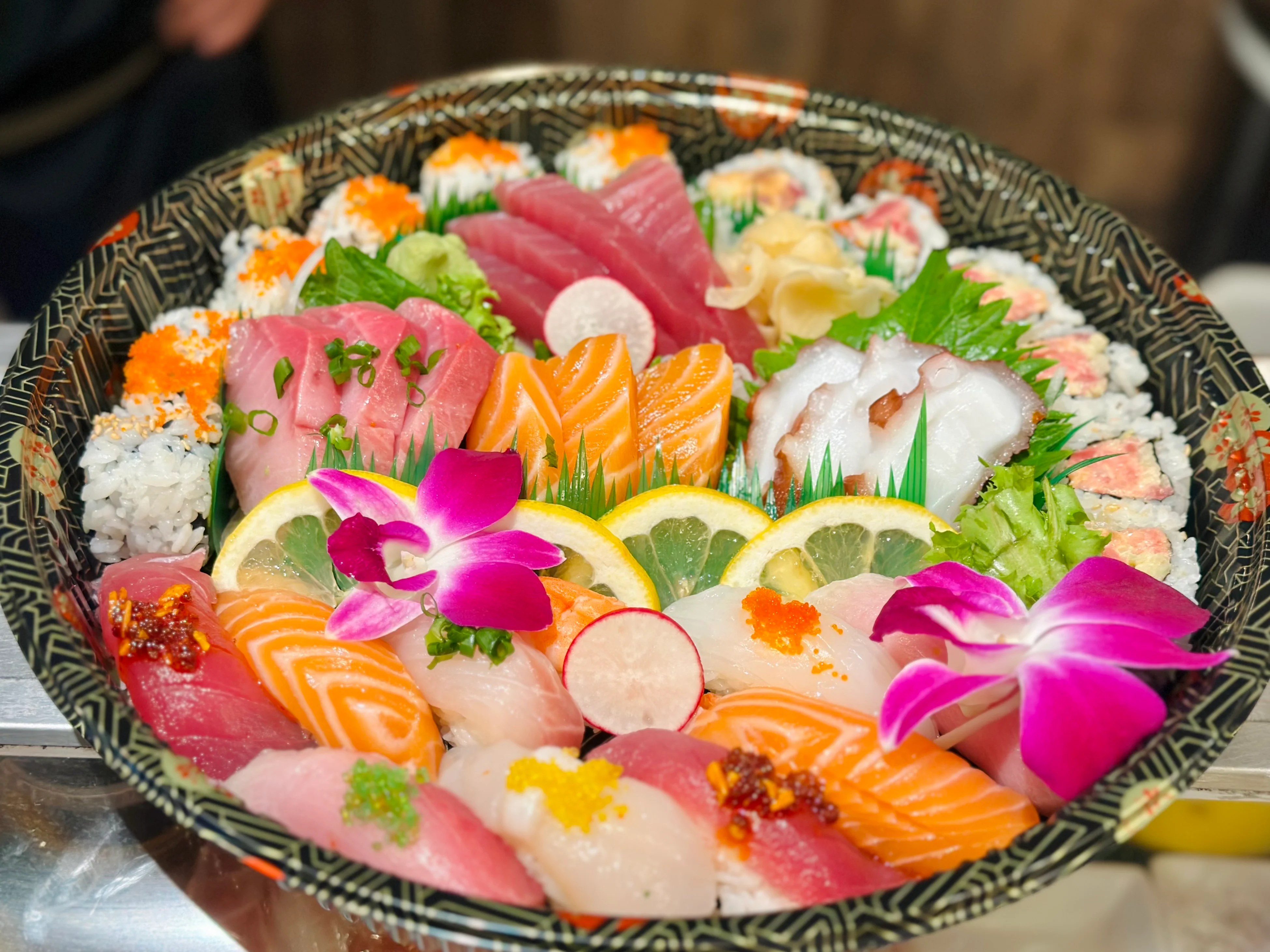 Assorted Japanese sushi platter with fresh sashimi and garnishes