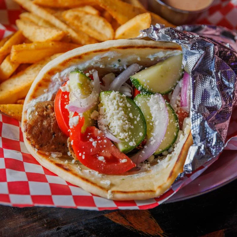 Delicious gourmet burger with fresh toppings on a wooden table