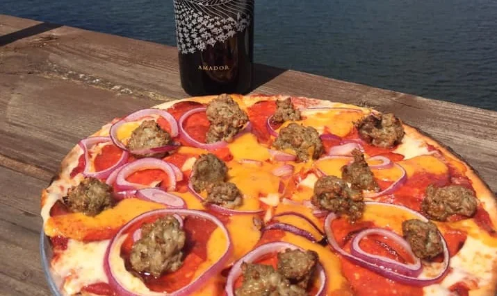 Delicious pepperoni pizza with sausage and red onions