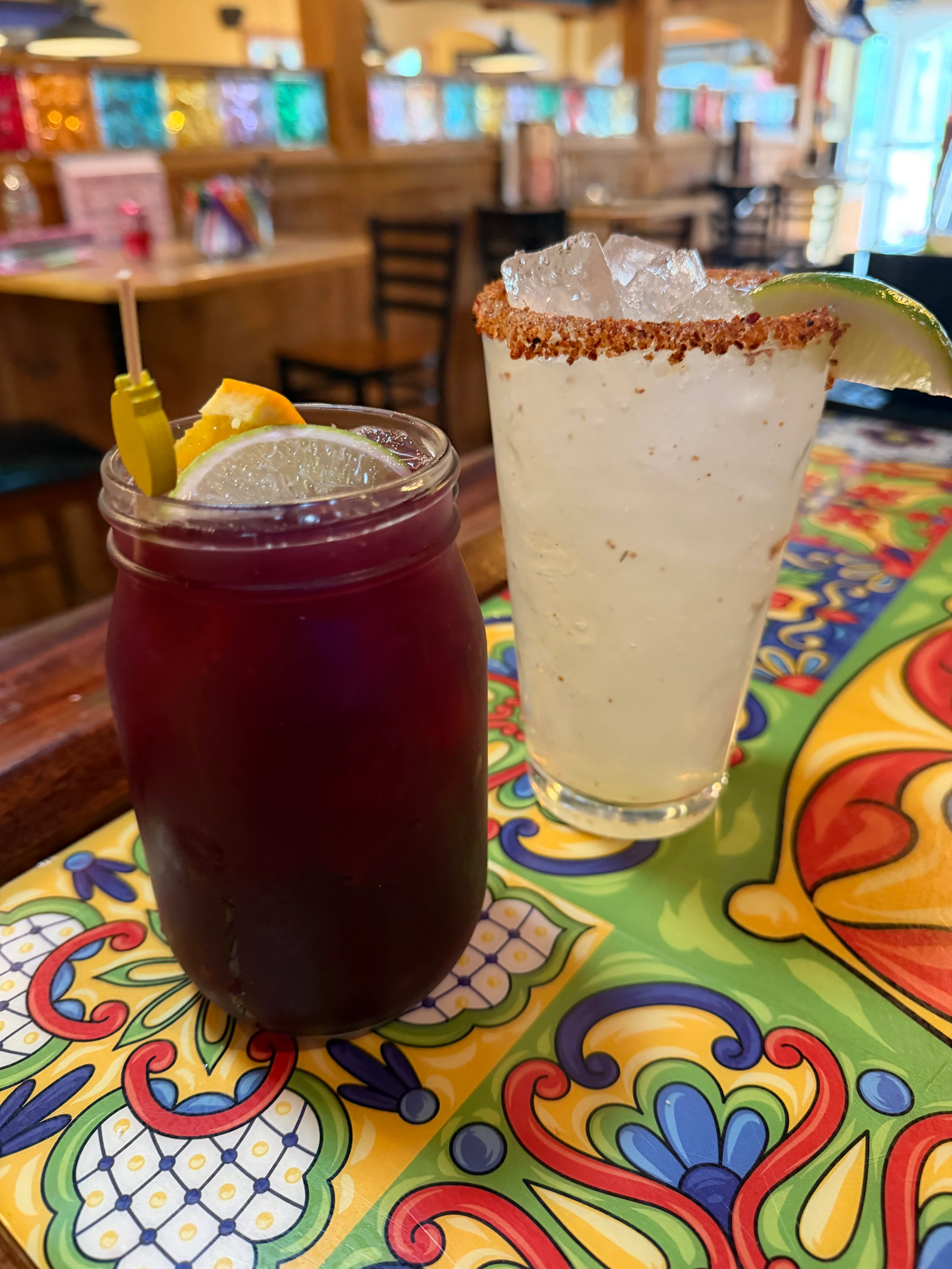 Colorful cocktails on a vibrant table in a lively restaurant setting