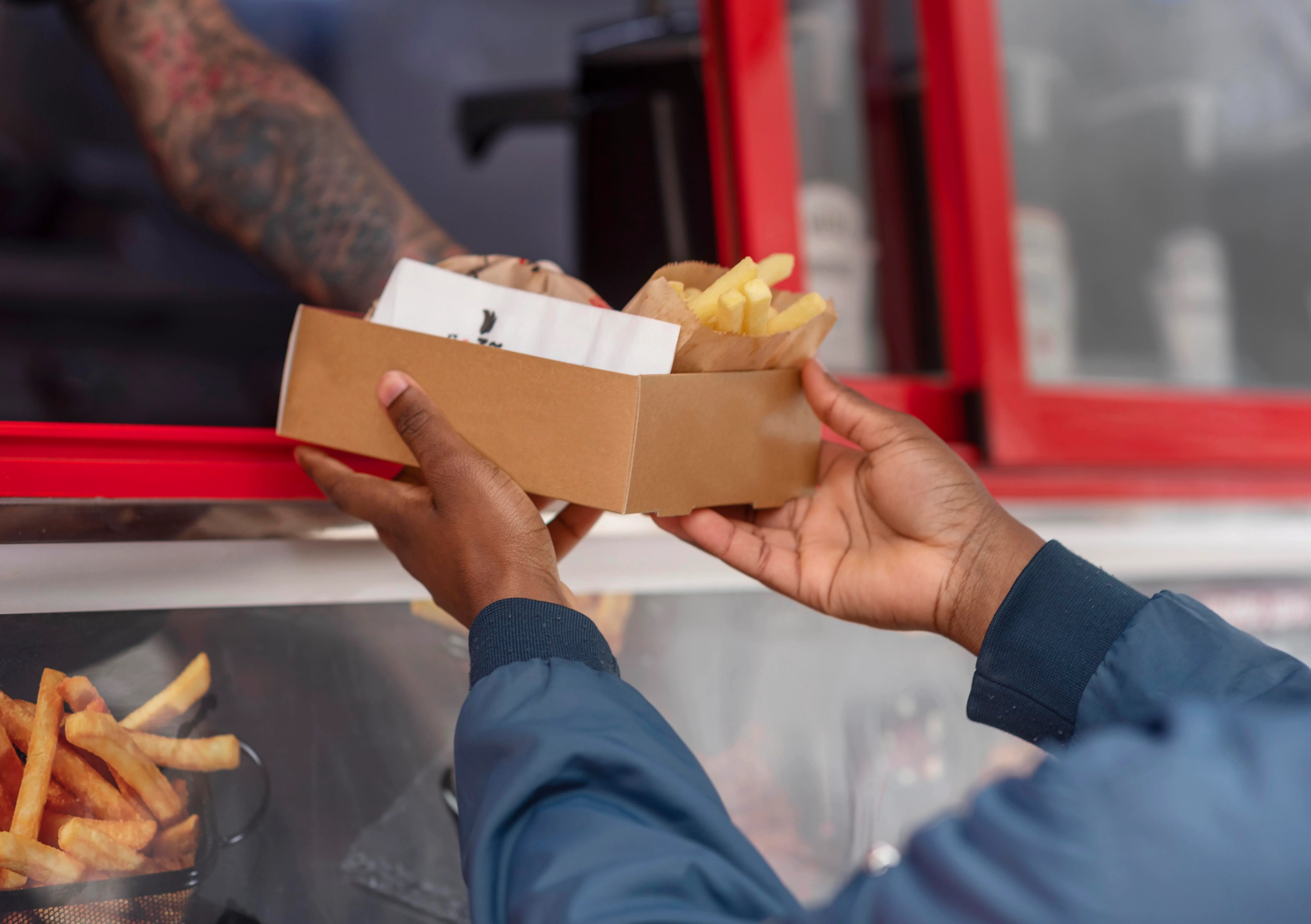 Two friends enjoying food from a food truck.
