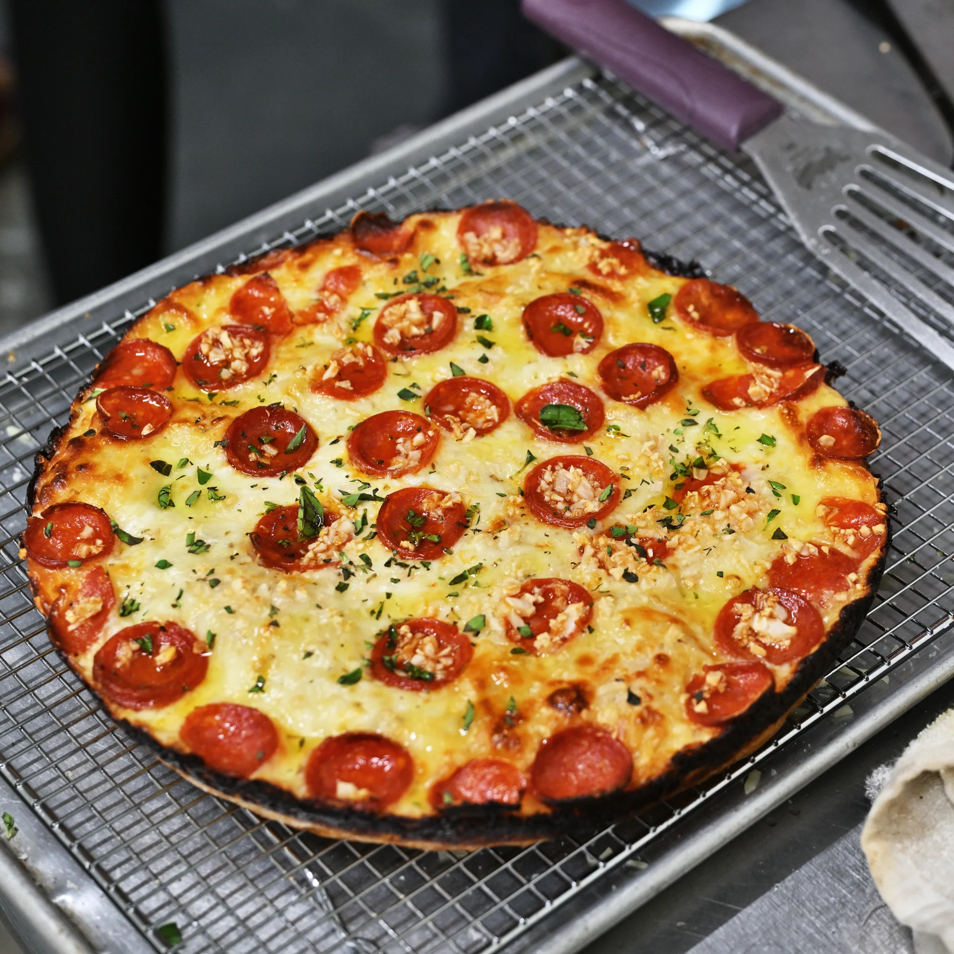 Pepperoni pizza with crispy crust and fresh herbs