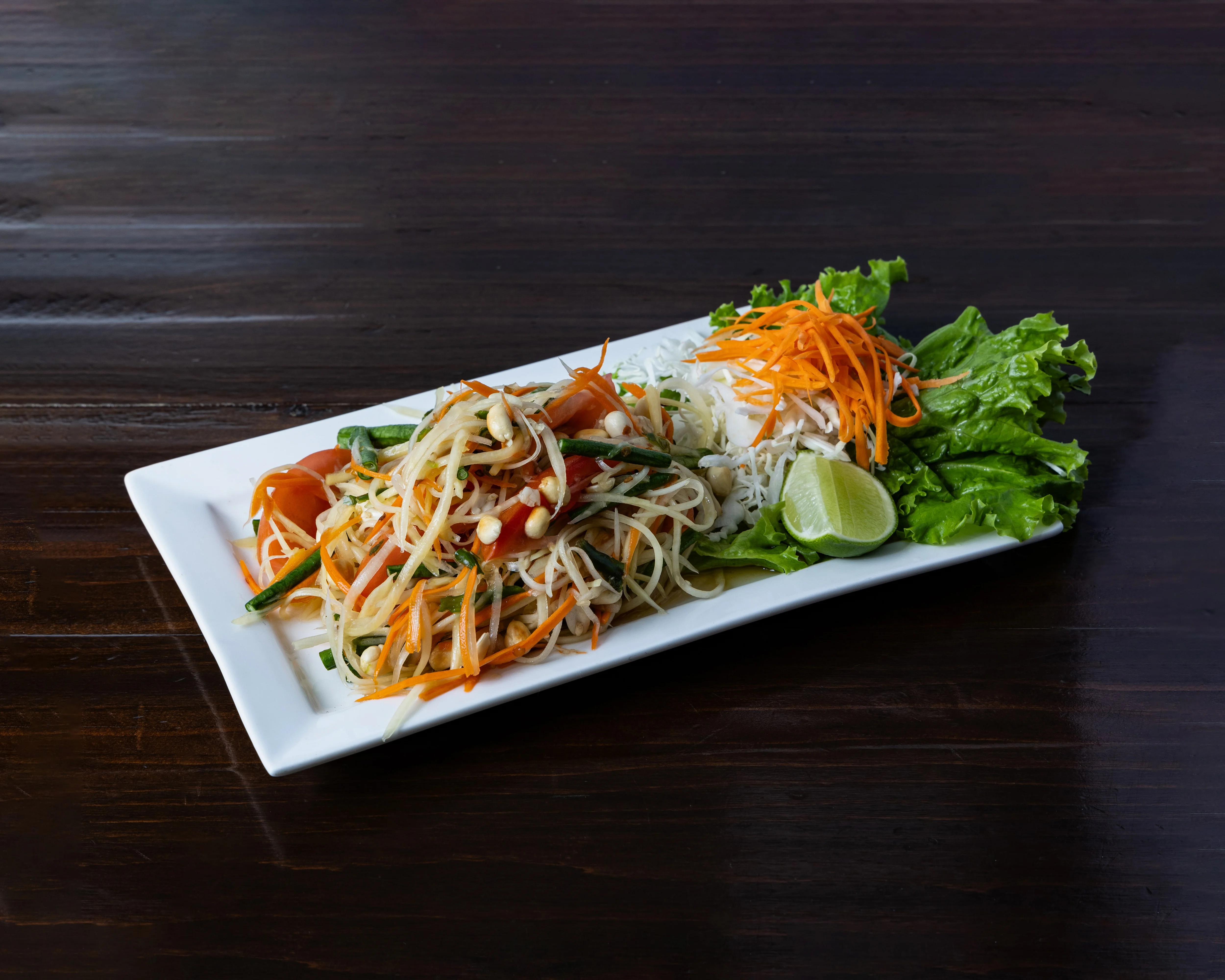 Papaya salad served in a bowl with fresh ingredients and vibrant colors.