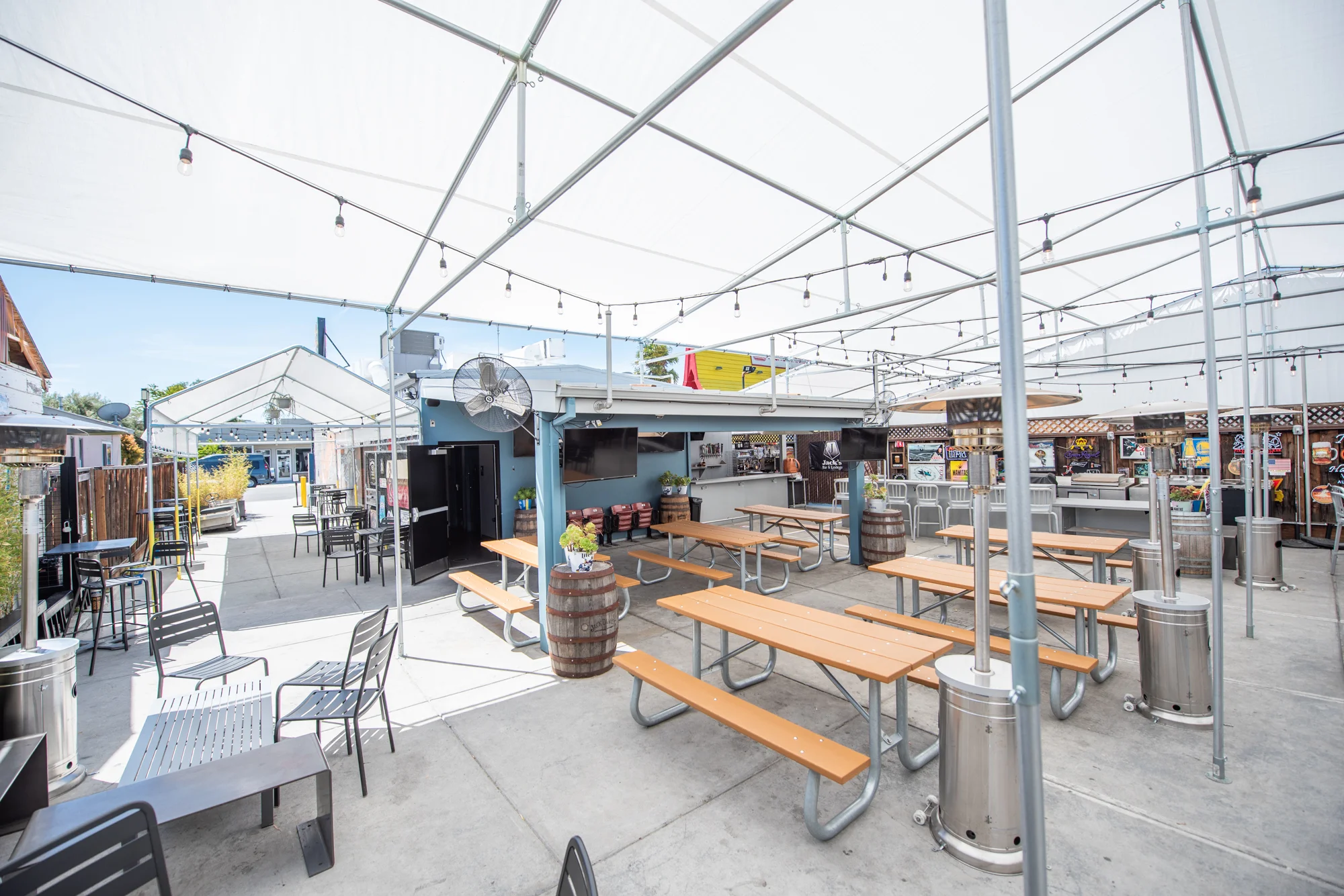 Outdoor dining area with picnic tables and canopies