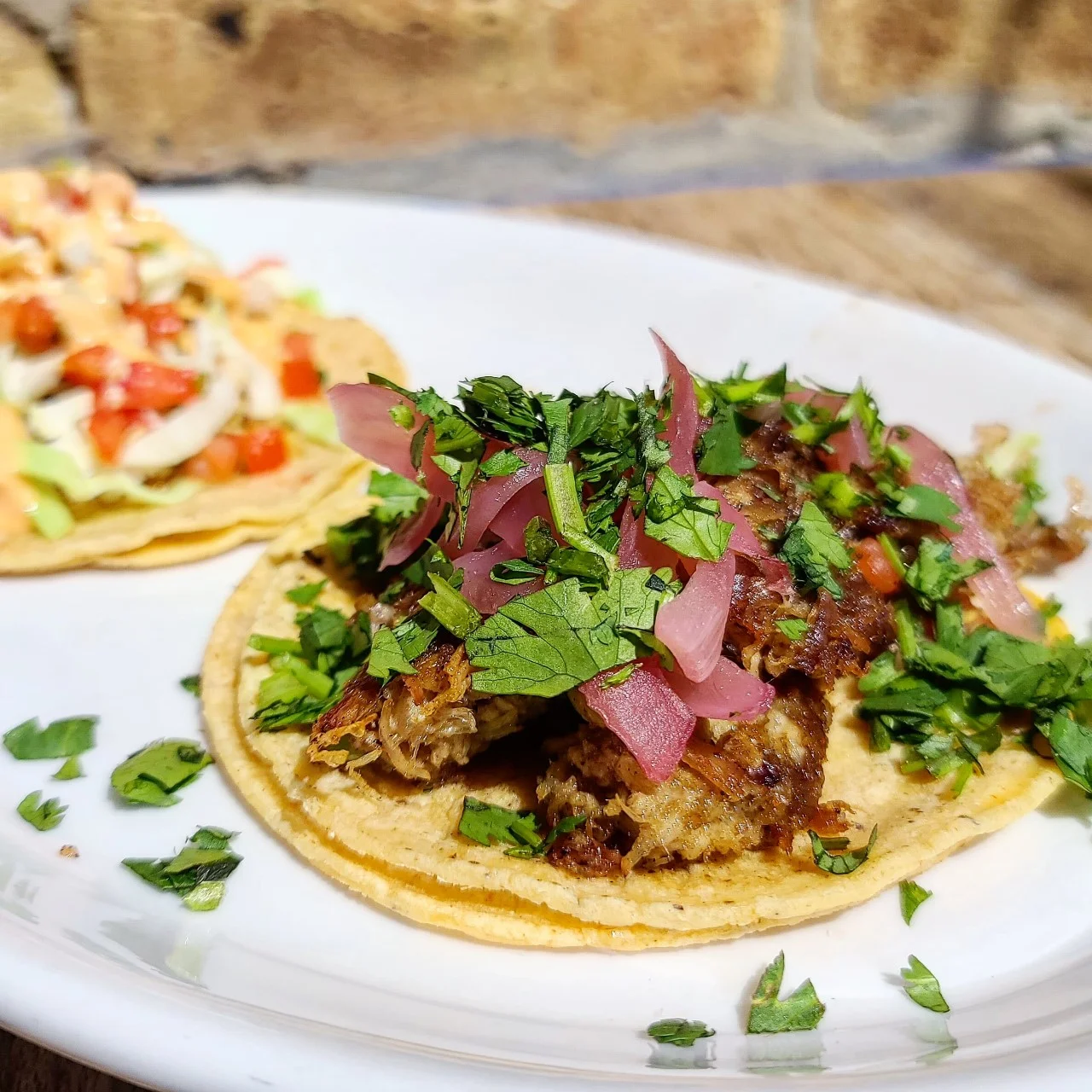 Delicious carnitas taco topped with fresh ingredients