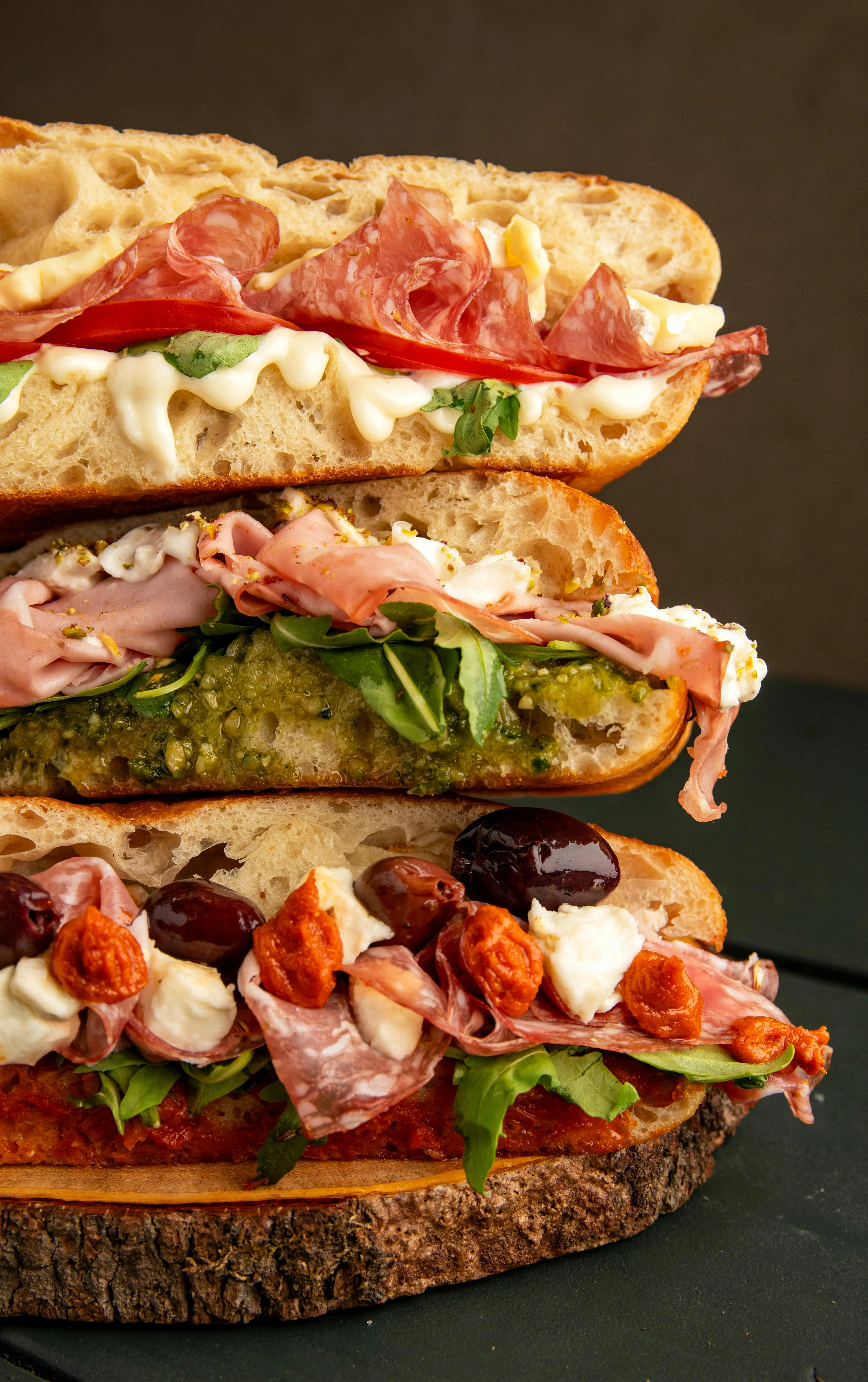 Italian sub sandwich stacked with meats and greens