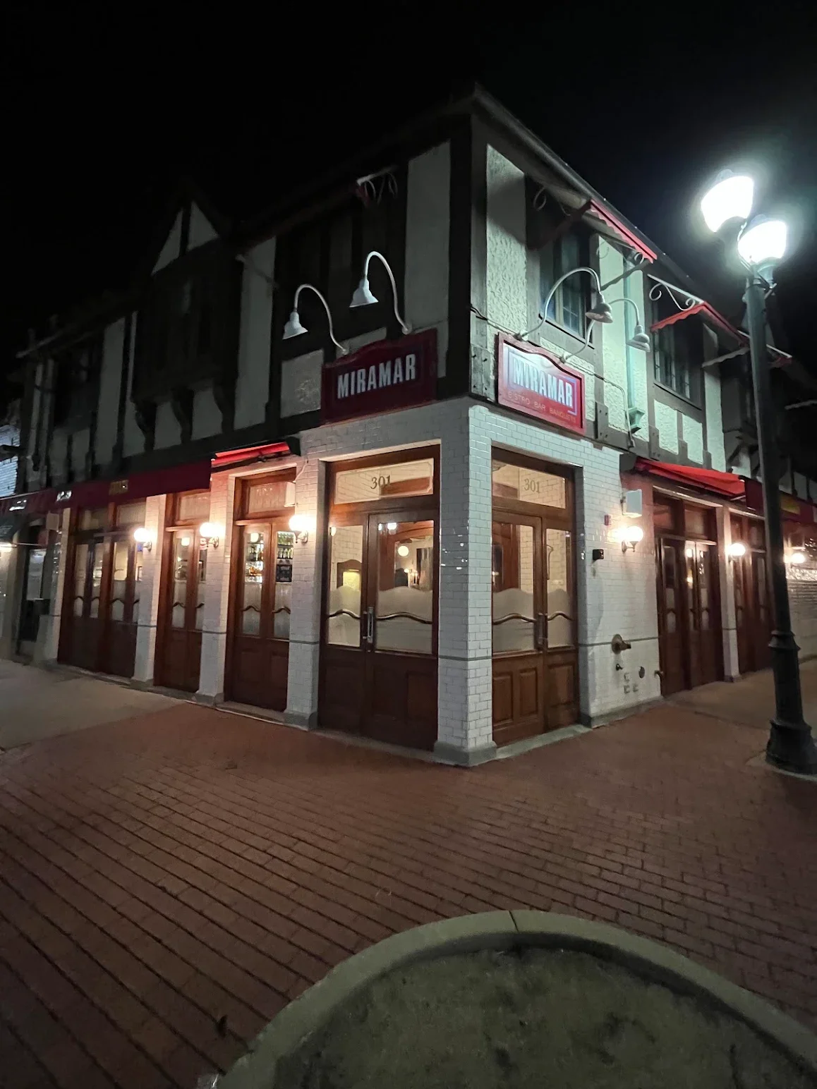 Charming restaurant exterior at night with warm lighting and inviting ambiance