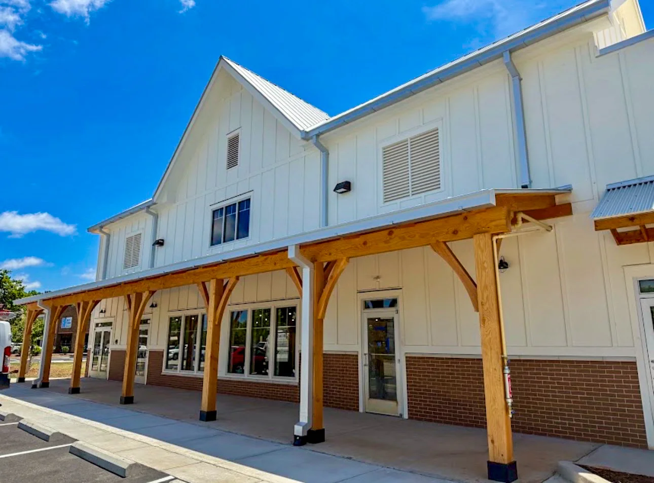 Modern restaurant exterior with wooden beams and large windows