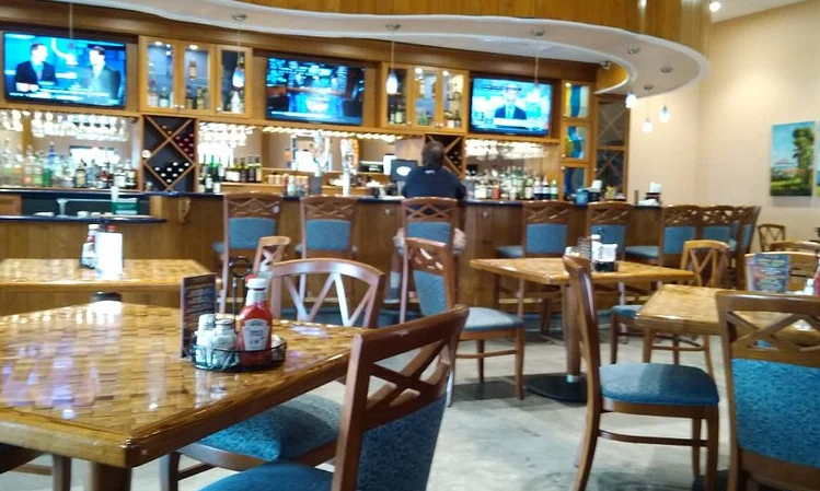 Cozy restaurant interior with wooden decor and bar area