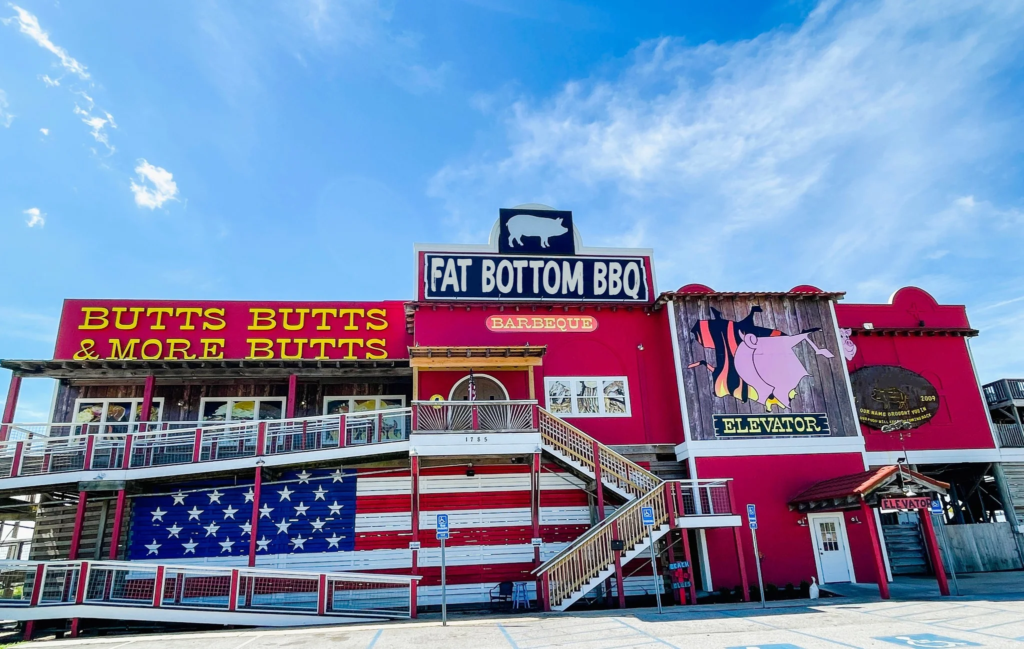 Colorful BBQ restaurant exterior with playful signage