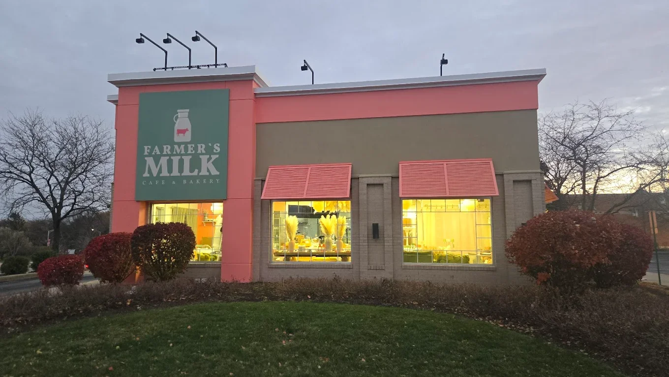 Exterior view of Farmer's Milk Cafe & Bakery with warm lighting
