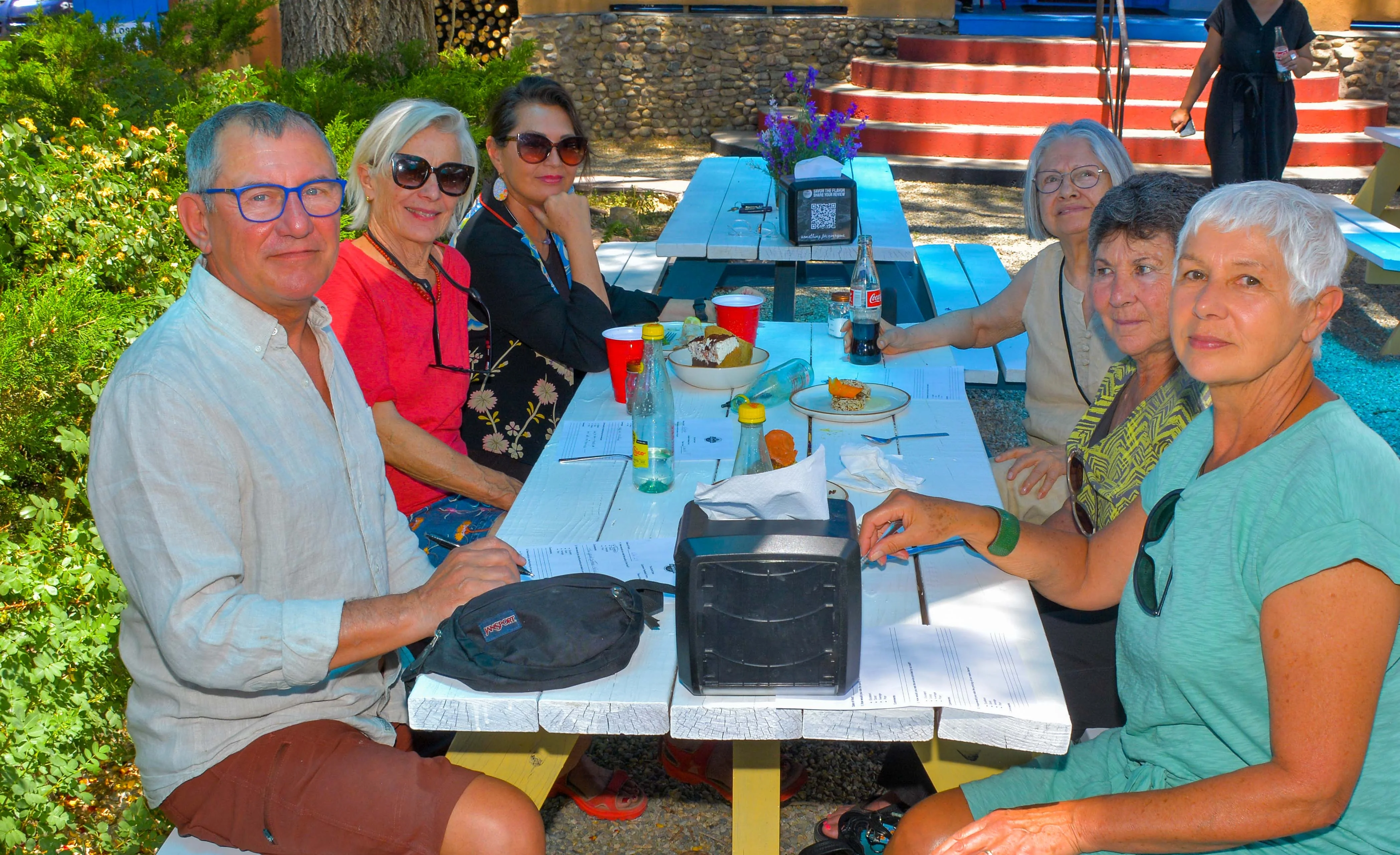 Group of friends enjoying a meal outdoors at a restaurant