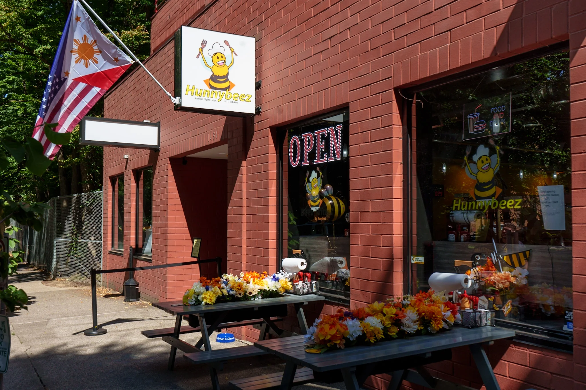 Exterior of Hunnybeez restaurant with open sign and floral decor