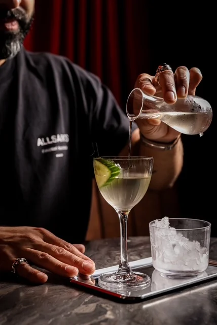 Bartender pouring a cocktail at a stylish bar