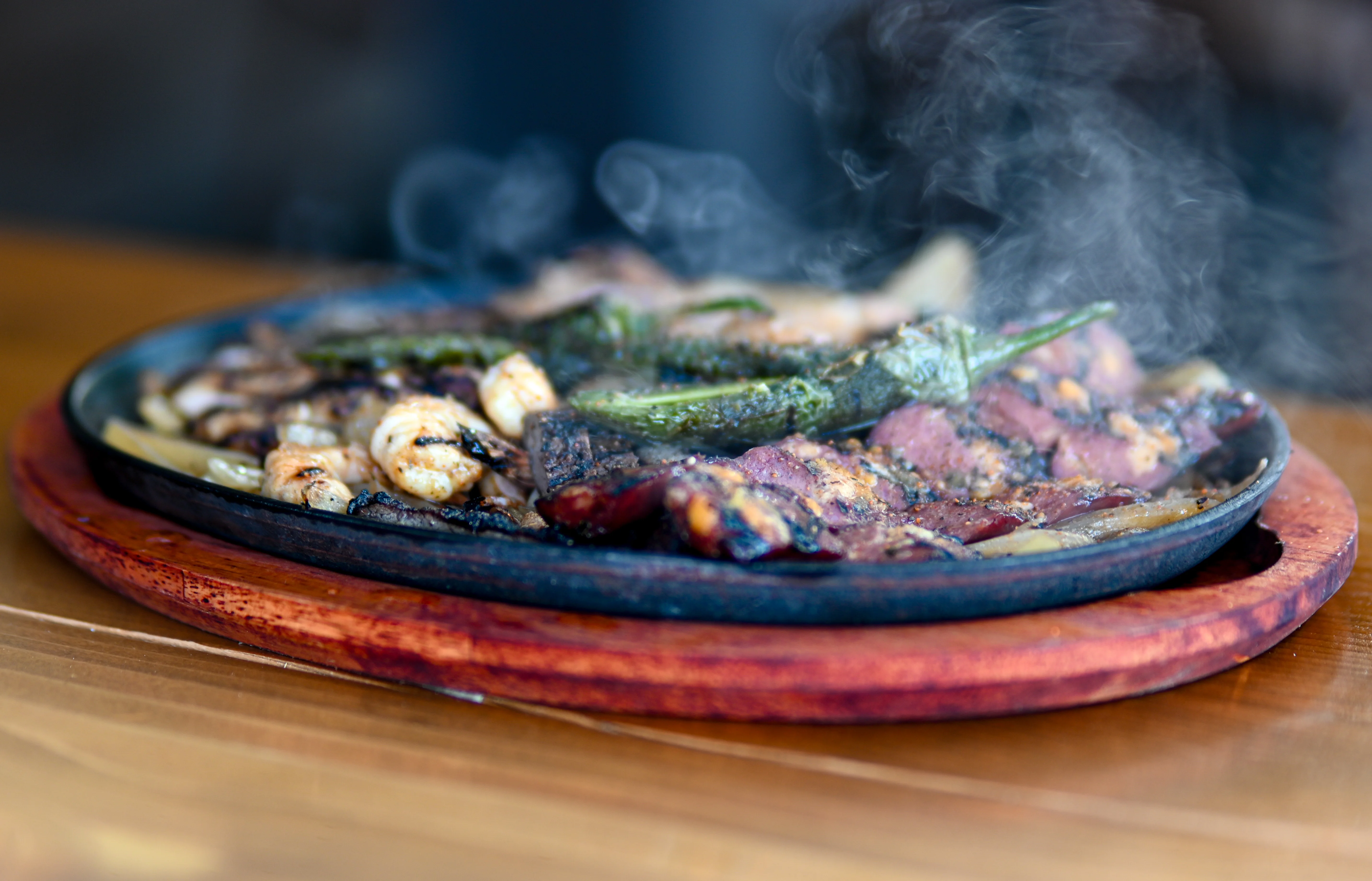 Sizzling fajitas served on a hot skillet