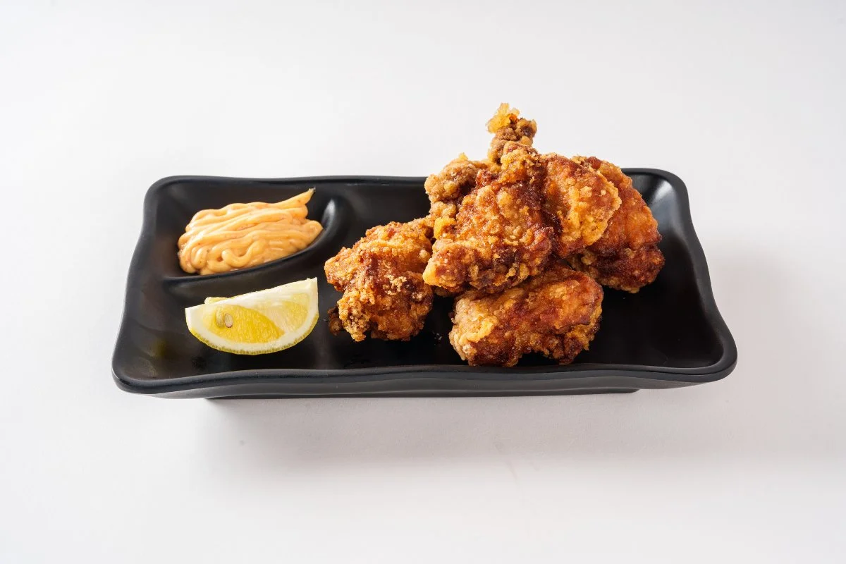 Delicious Chicken Karaage served with dipping sauce and garnishes.