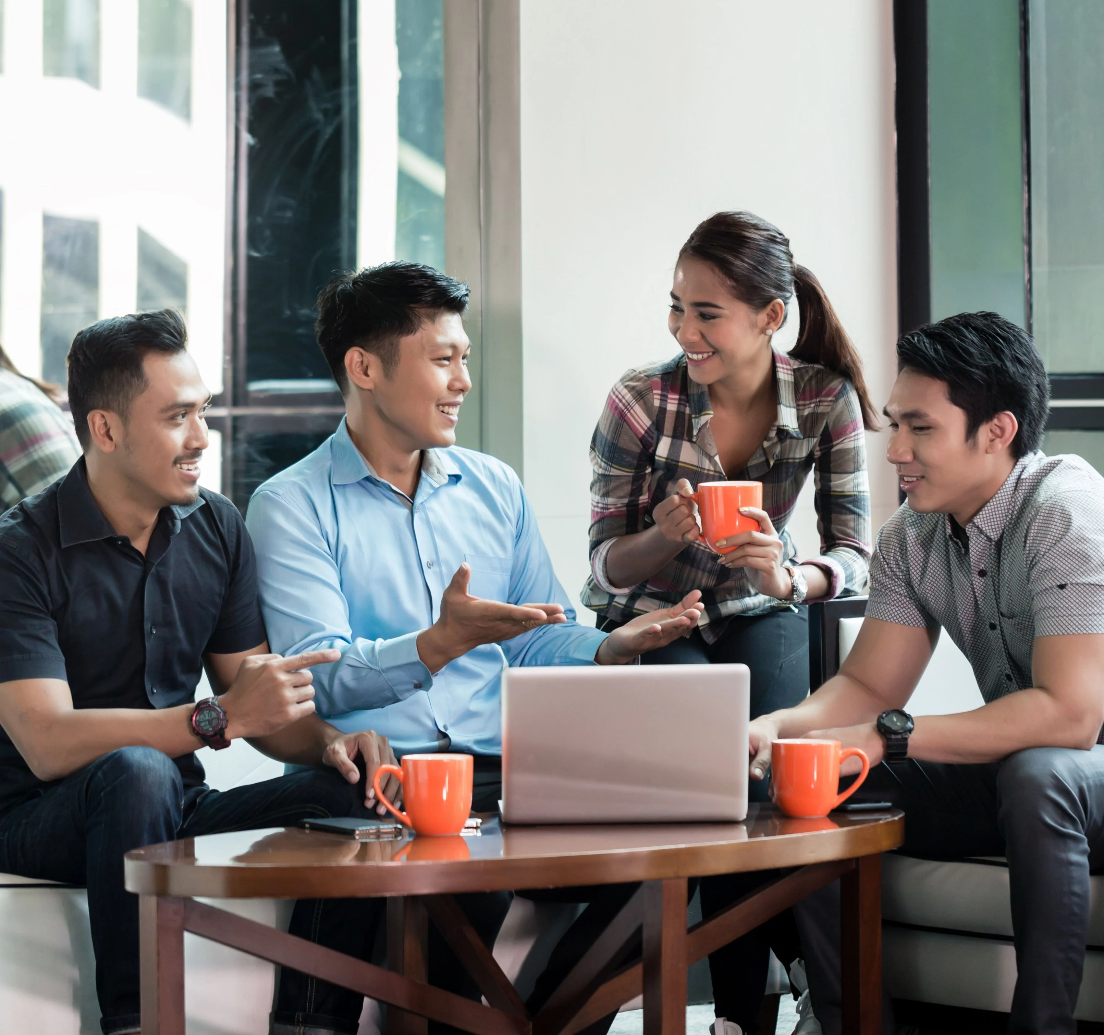 Friends enjoying coffee and conversation together in a bright cafe