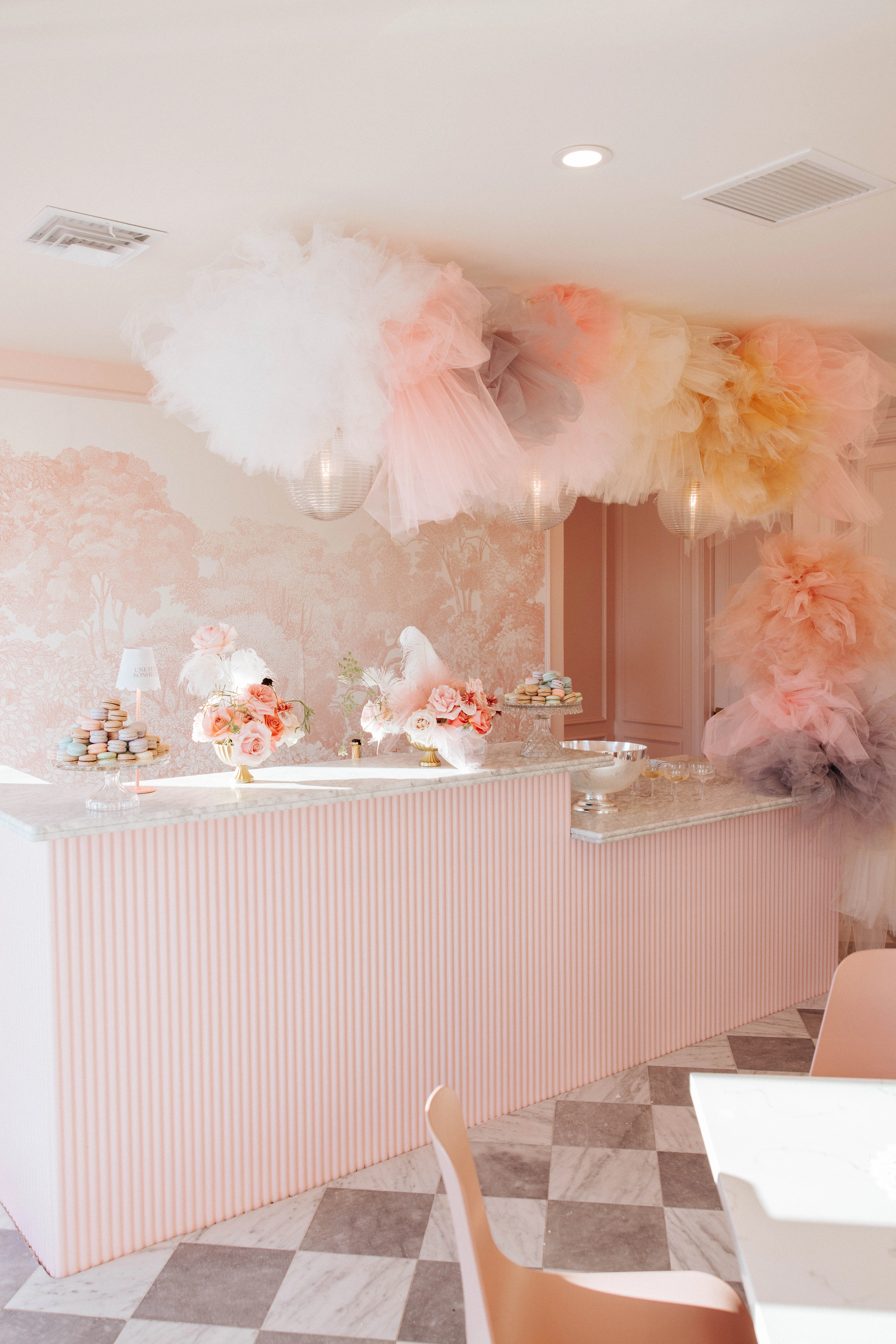 Charming dessert shop interior with pastel decor and floral arrangements