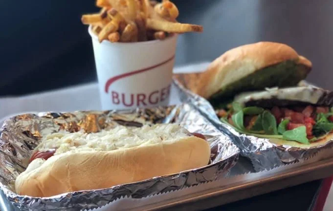 Burger Fresh burger, hot dog, and fries on a tray