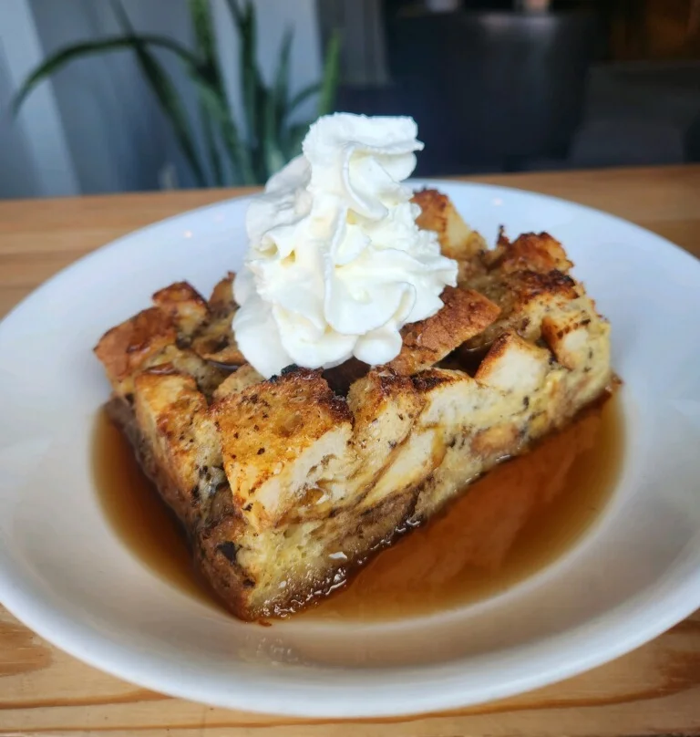 Delicious bread pudding topped with whipped cream