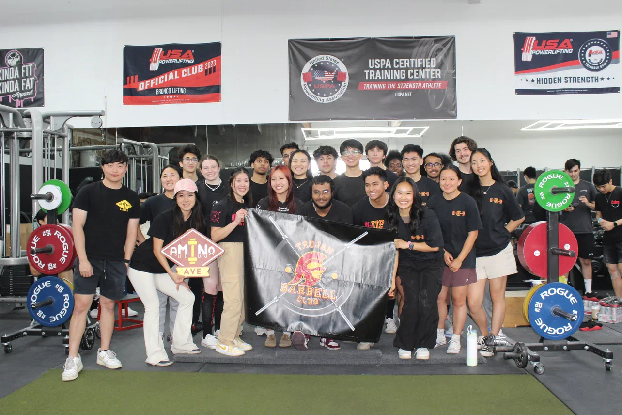 Group photo of powerlifting club members at a training center