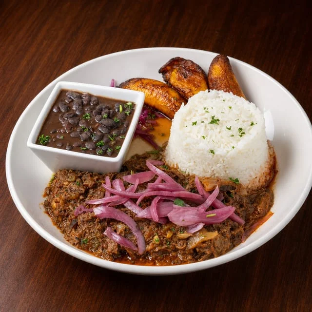 Cuban ropa vieja served with rice and black beans