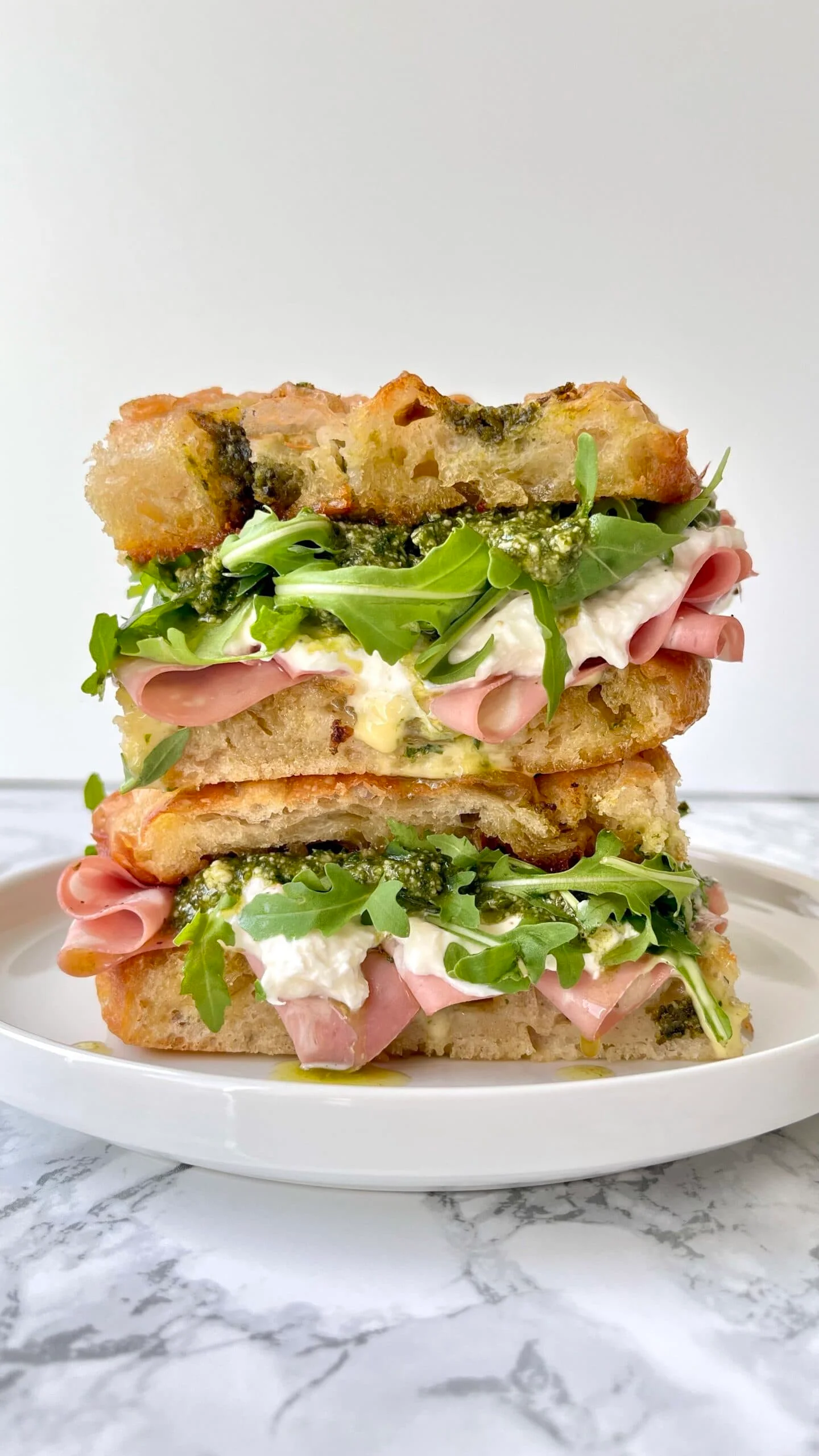 A delicious mortadella sandwich with fresh ingredients and vibrant colors.