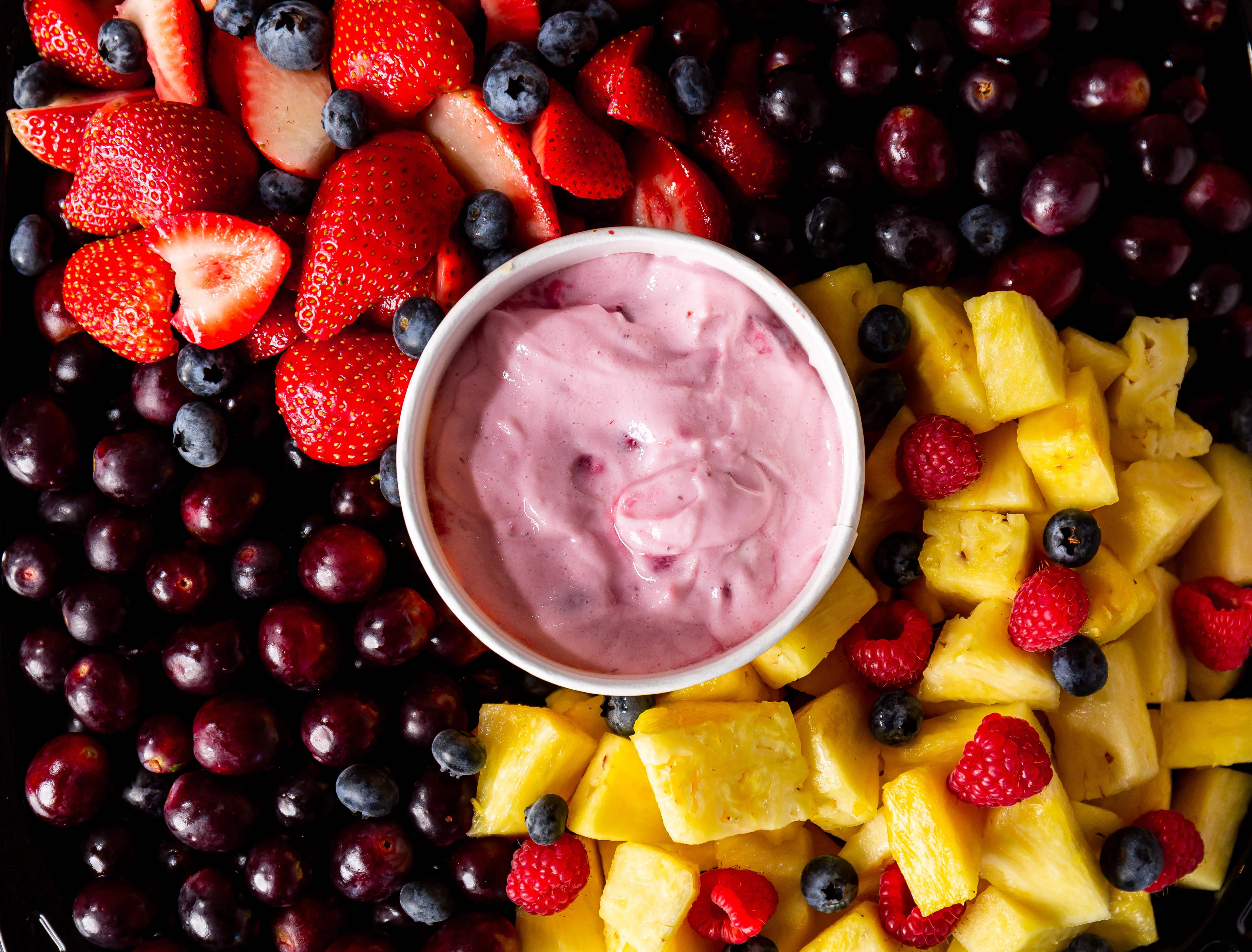 Colorful fruit platter with yogurt dip
