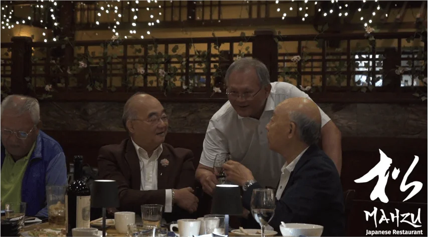 Friends laughing and toasting with wine at a private dinner at Mahzu East Windsor, BYOB