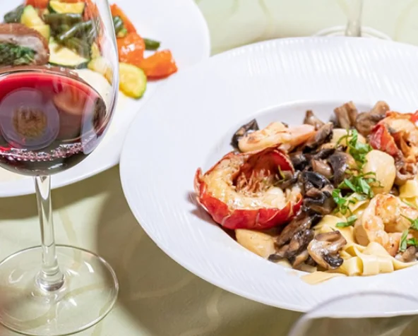 Lobster fettuccine with mushrooms in a fine dining setting