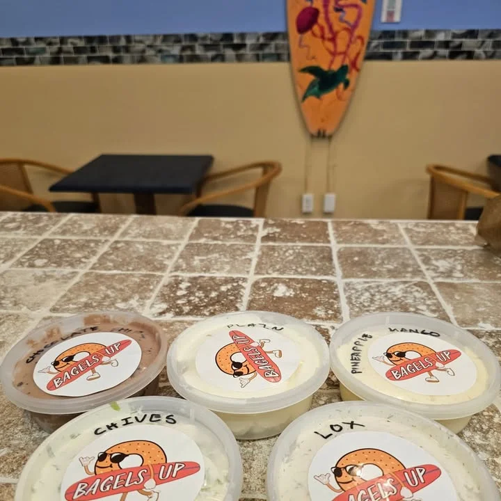 Variety of bagel spreads in a cozy cafe setting