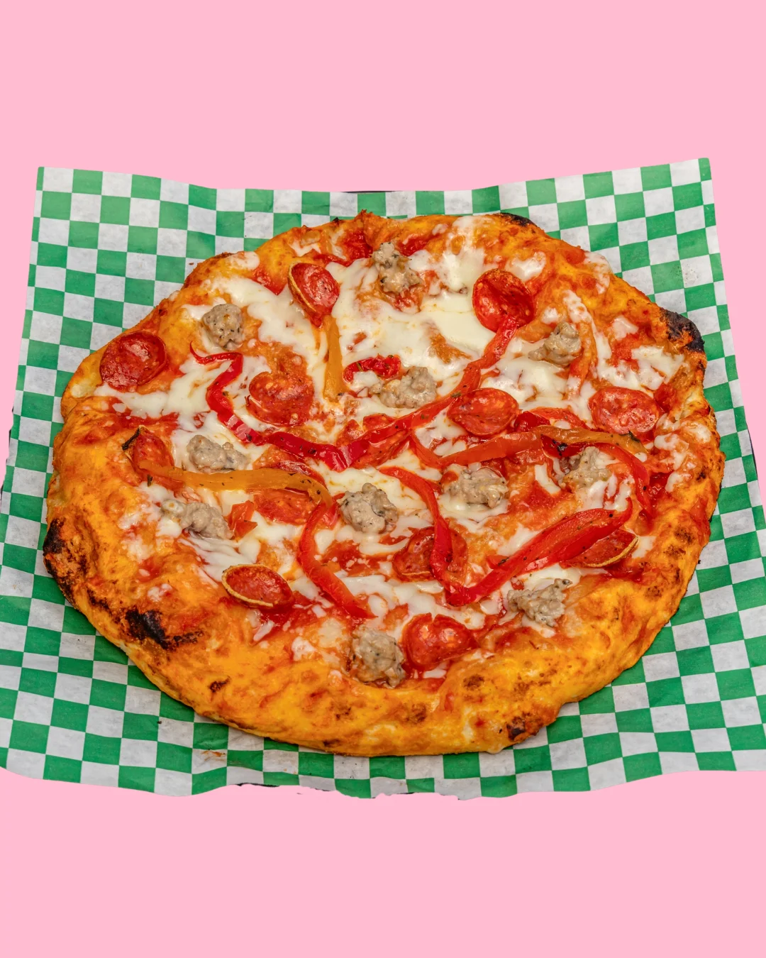Delicious pepperoni pizza on a checkered paper