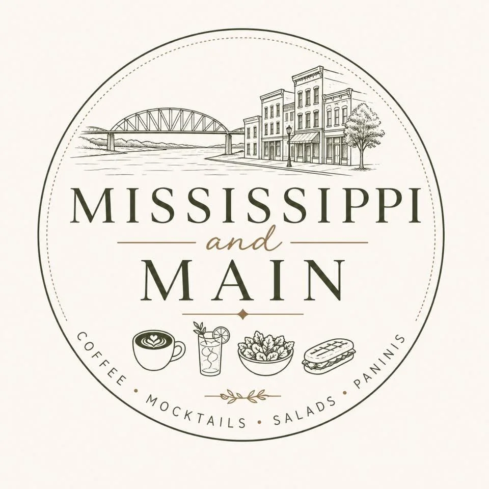 A circular logo featuring an illustration of a town with buildings and a bridge over water. The logo includes the text 'Mississippi and Main' and icons representing coffee, mocktails, salads, and paninis.