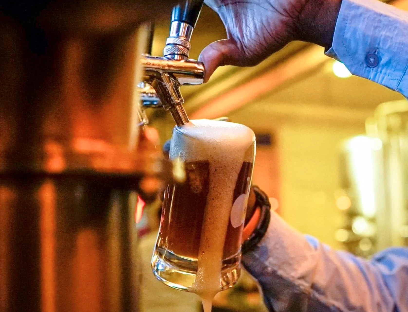 Bartender pouring craft beer into a glass
