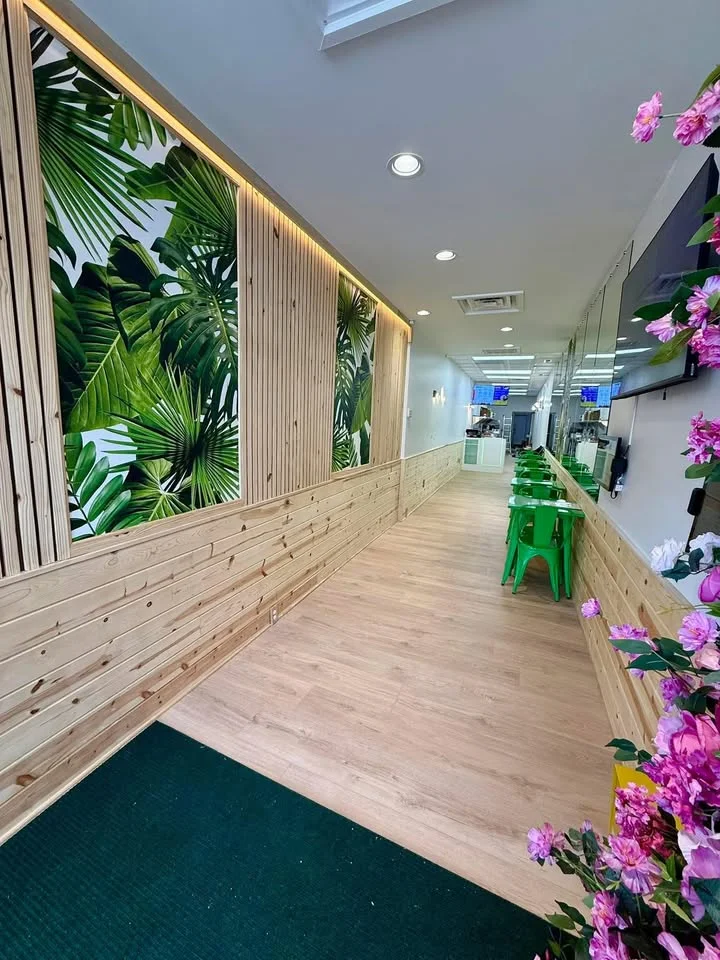 Modern restaurant interior with tropical decor and wooden accents