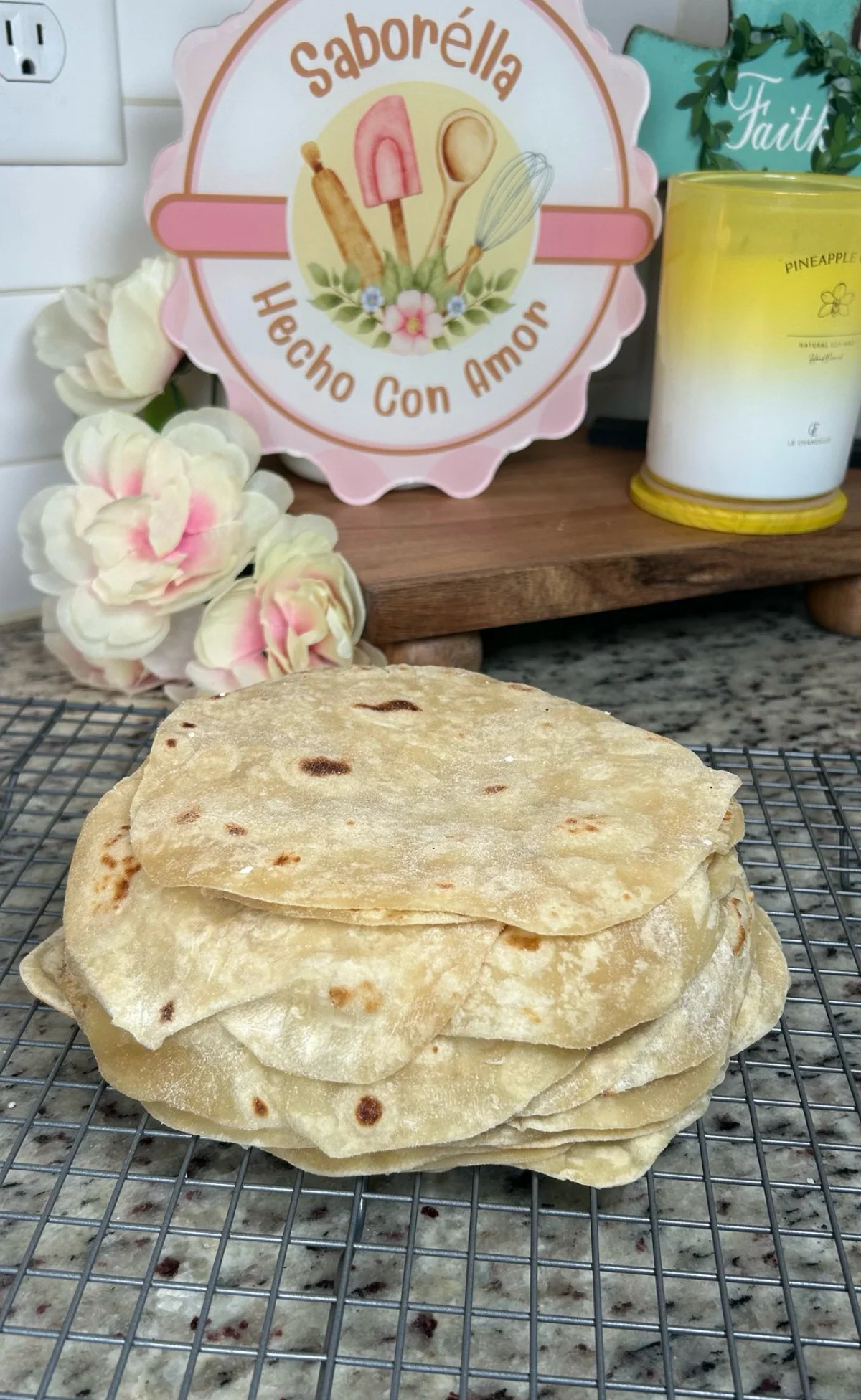 Freshly made tortillas stacked on a cooling rack