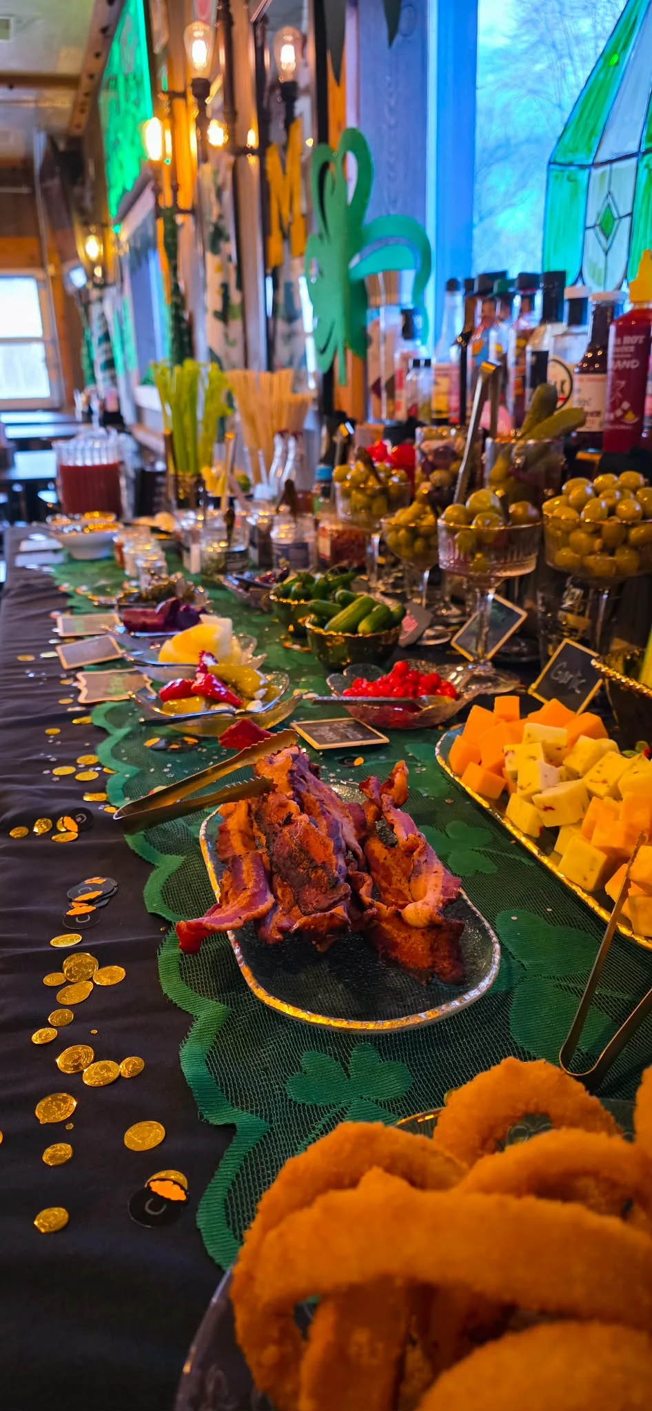 Festive buffet table with assorted appetizers and drinks for St. Patrick's Day