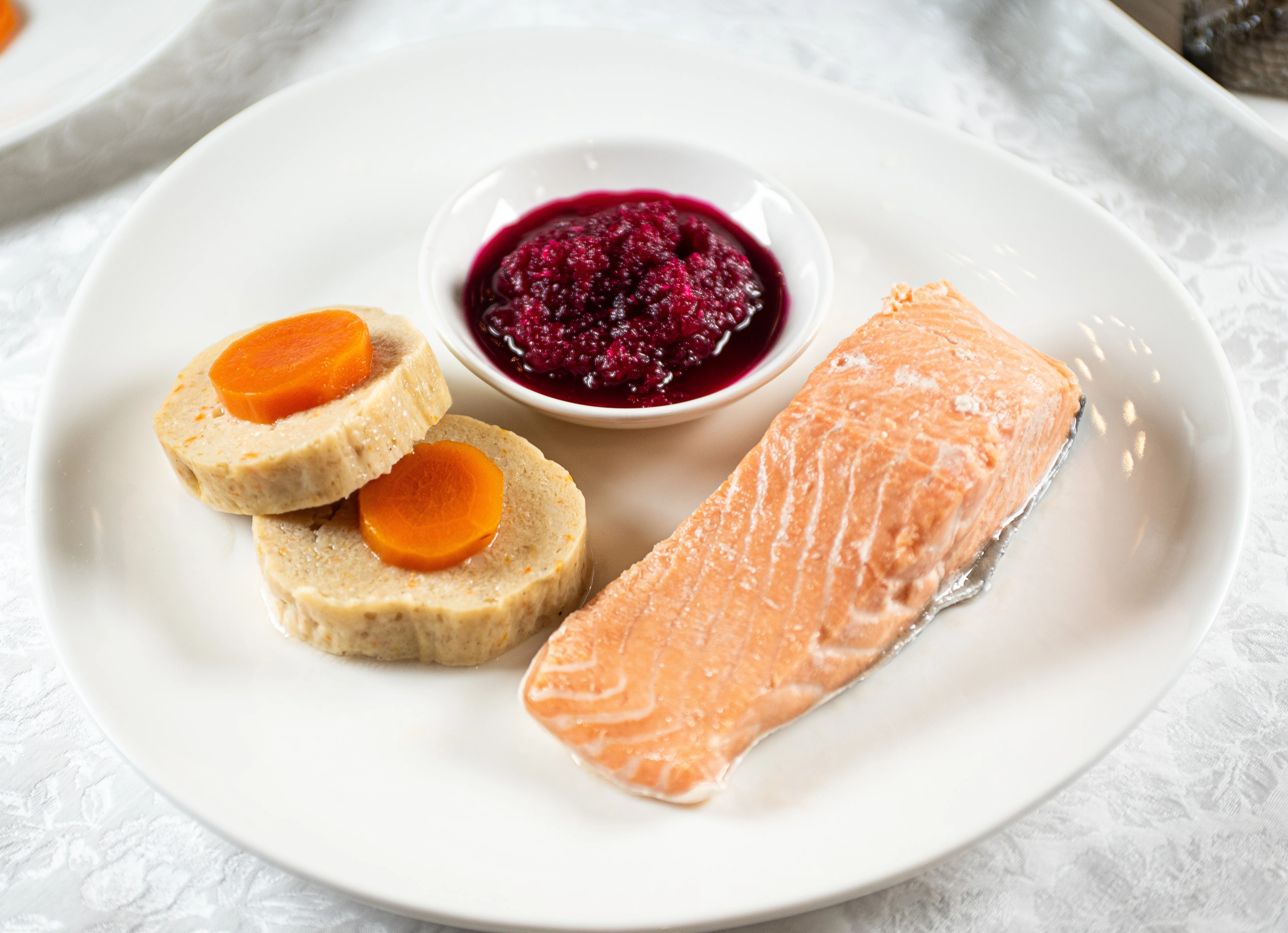 Baked salmon with carrot terrine and berry sauce