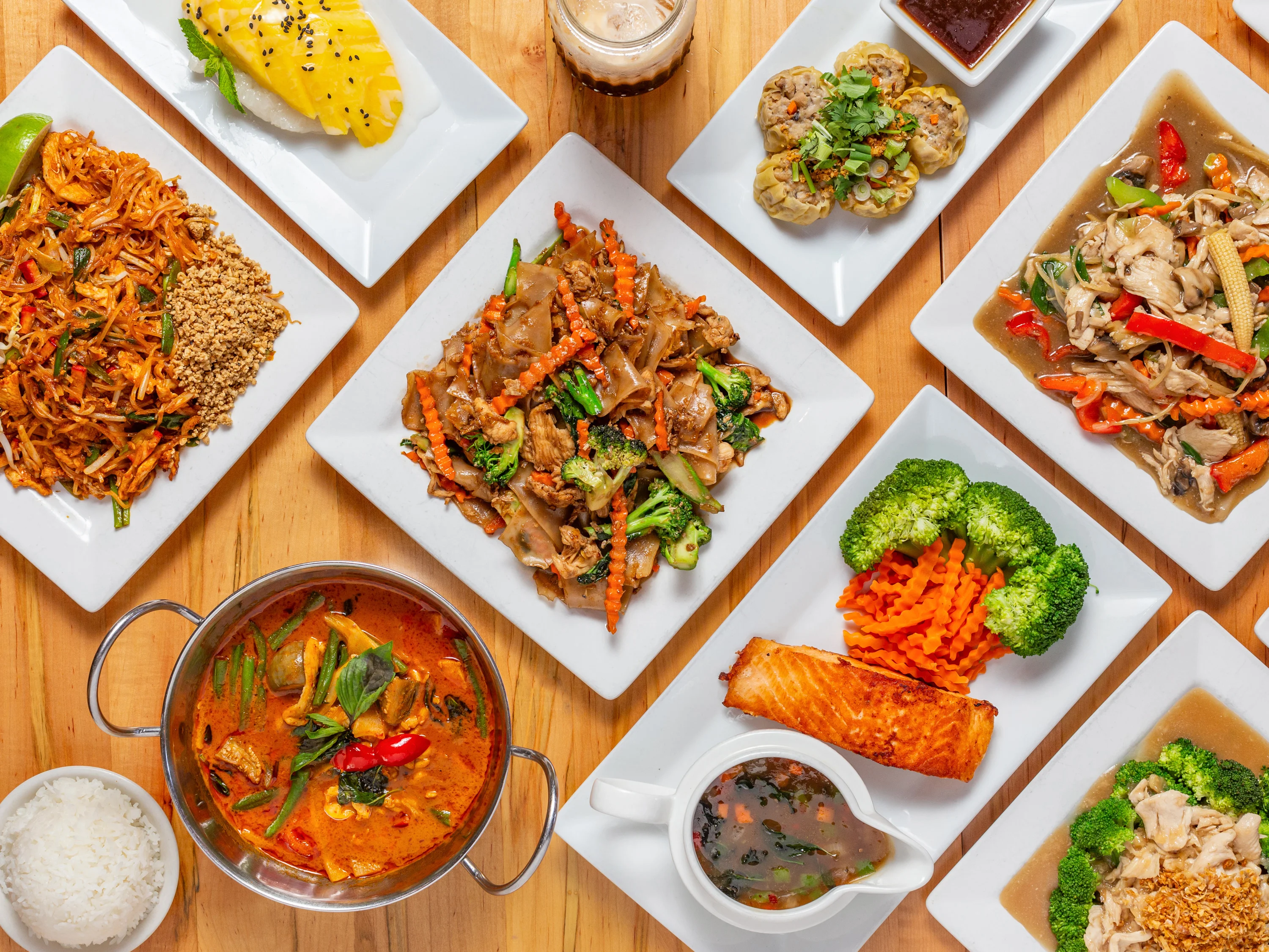 Assorted Thai dishes including pad thai and red curry