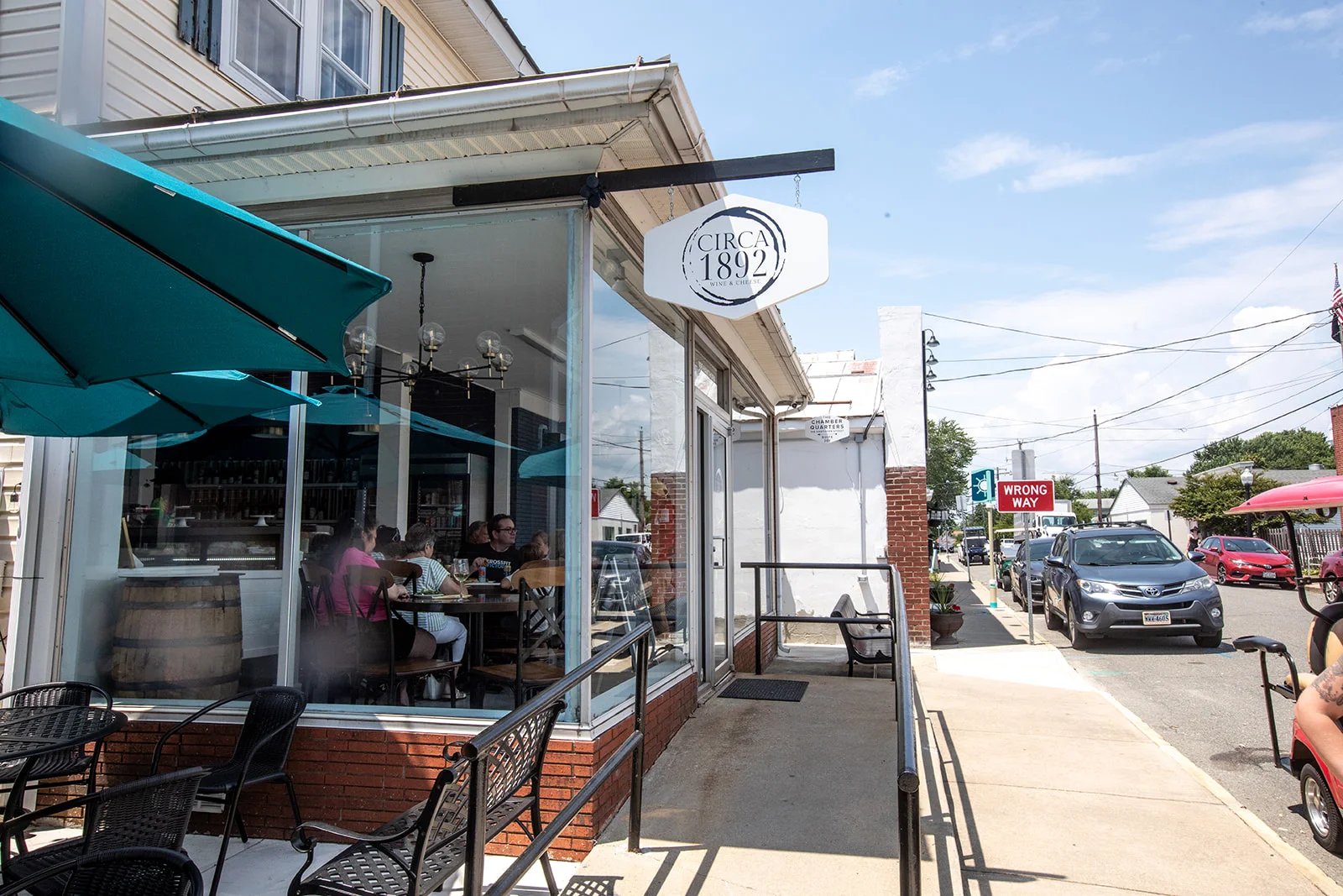 Charming restaurant exterior with outdoor seating and umbrellas