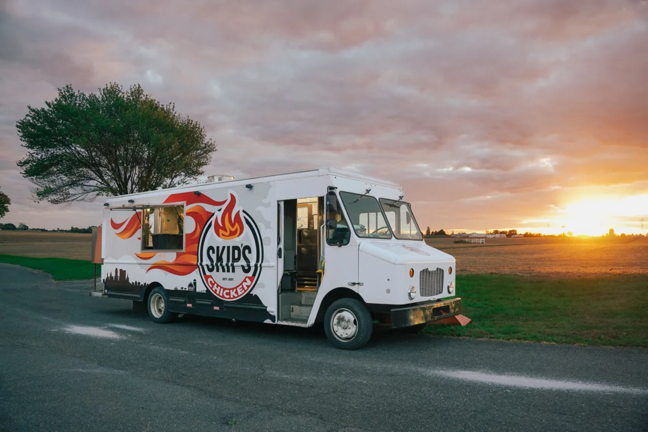 Food truck serving delicious fried chicken at sunset