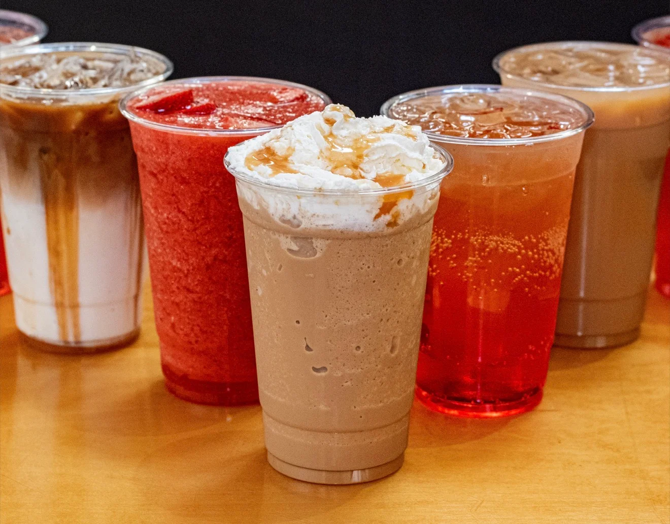 Frosted caramel drink topped with whipped cream and caramel drizzle.