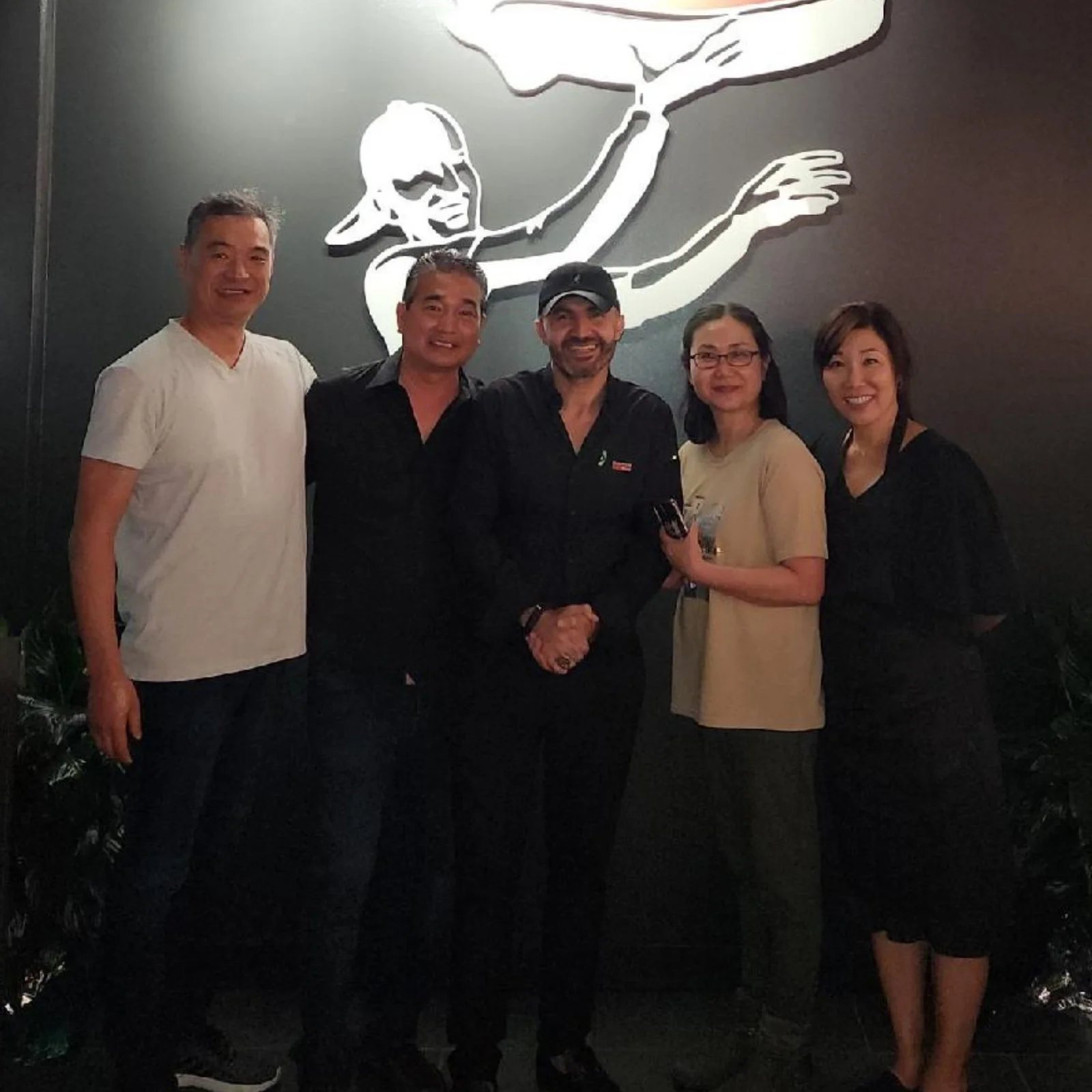 Group of restaurant professionals posing together in a modern dining space
