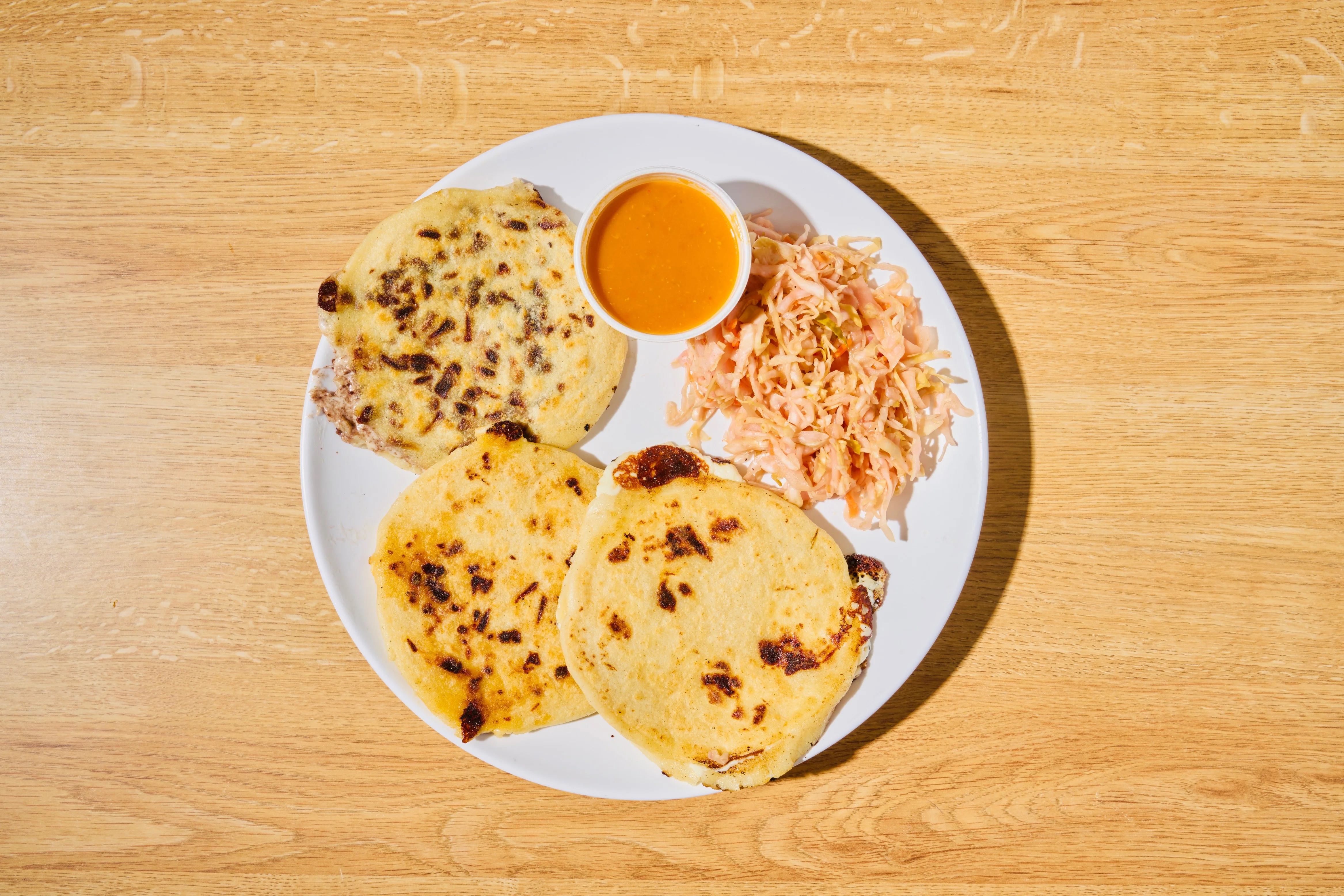 El Salvadoran pupusas served with slaw and sauce