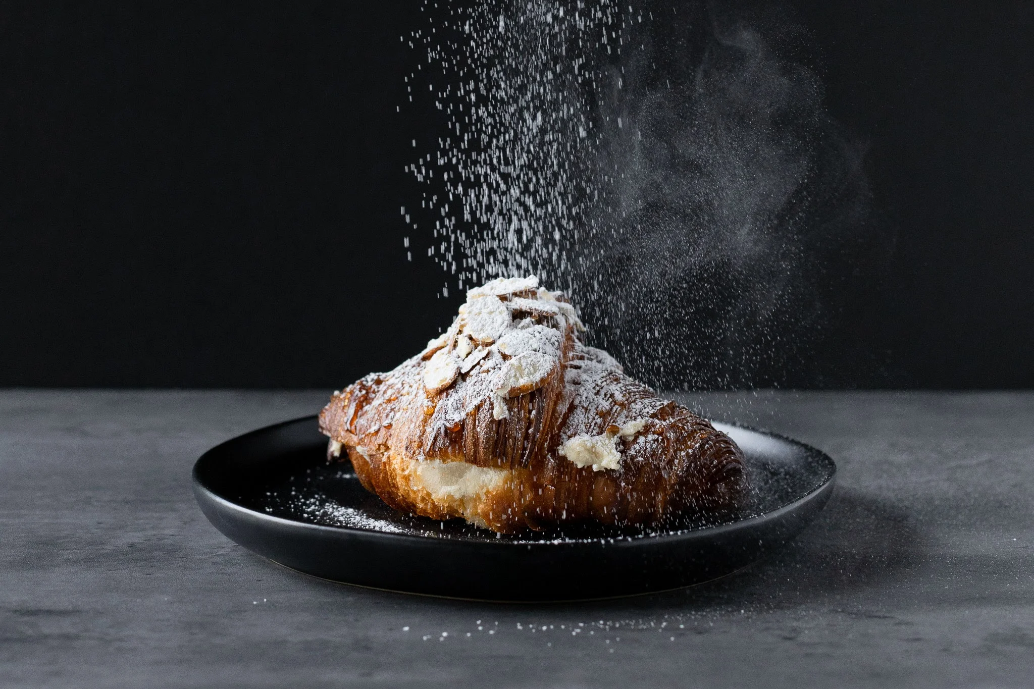 Almond croissant dusted with powdered sugar